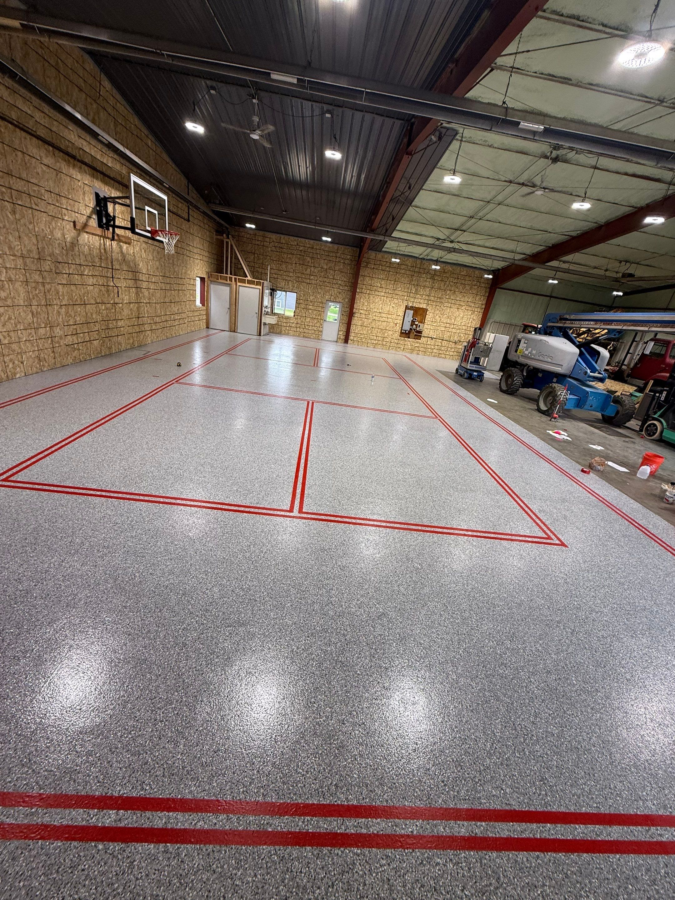 Custom Polyurea Shop Floor with Basketball Court Lines in Rock Valley by Select Painting, Coatings & Garage Cabinets