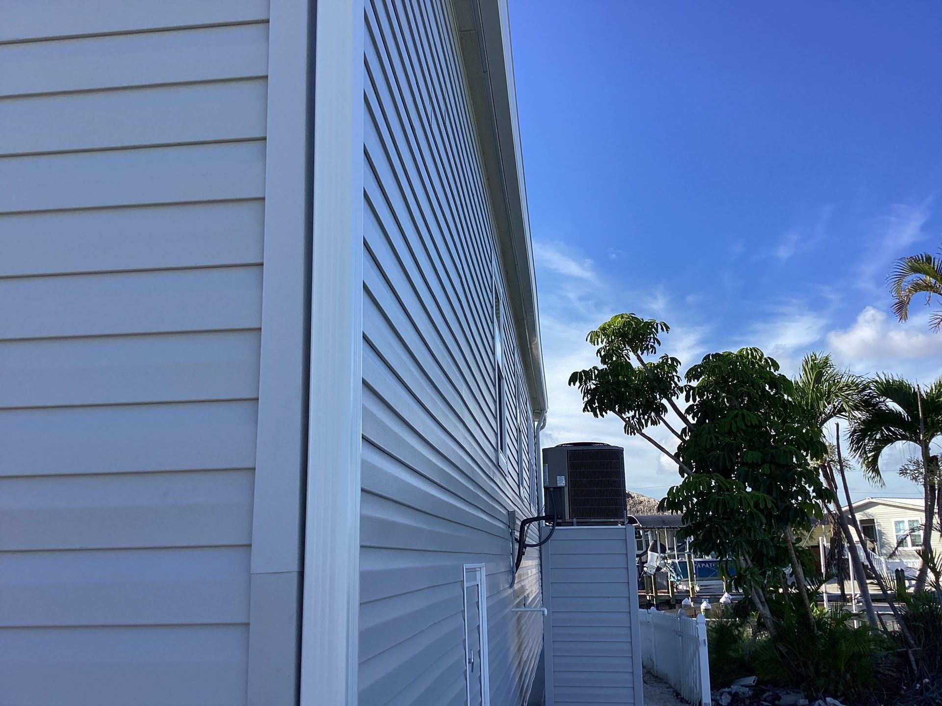 White Downspouts Installation in St. James City by Gutter Professors