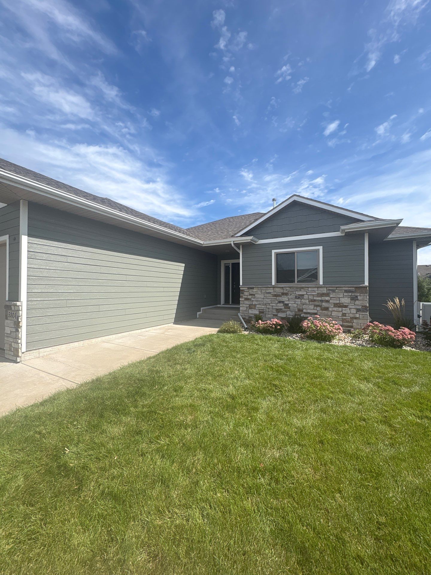Full Exterior Home Painting on Blue Lap Siding in Sioux Falls by Select Painting, Coatings & Garage Cabinets
