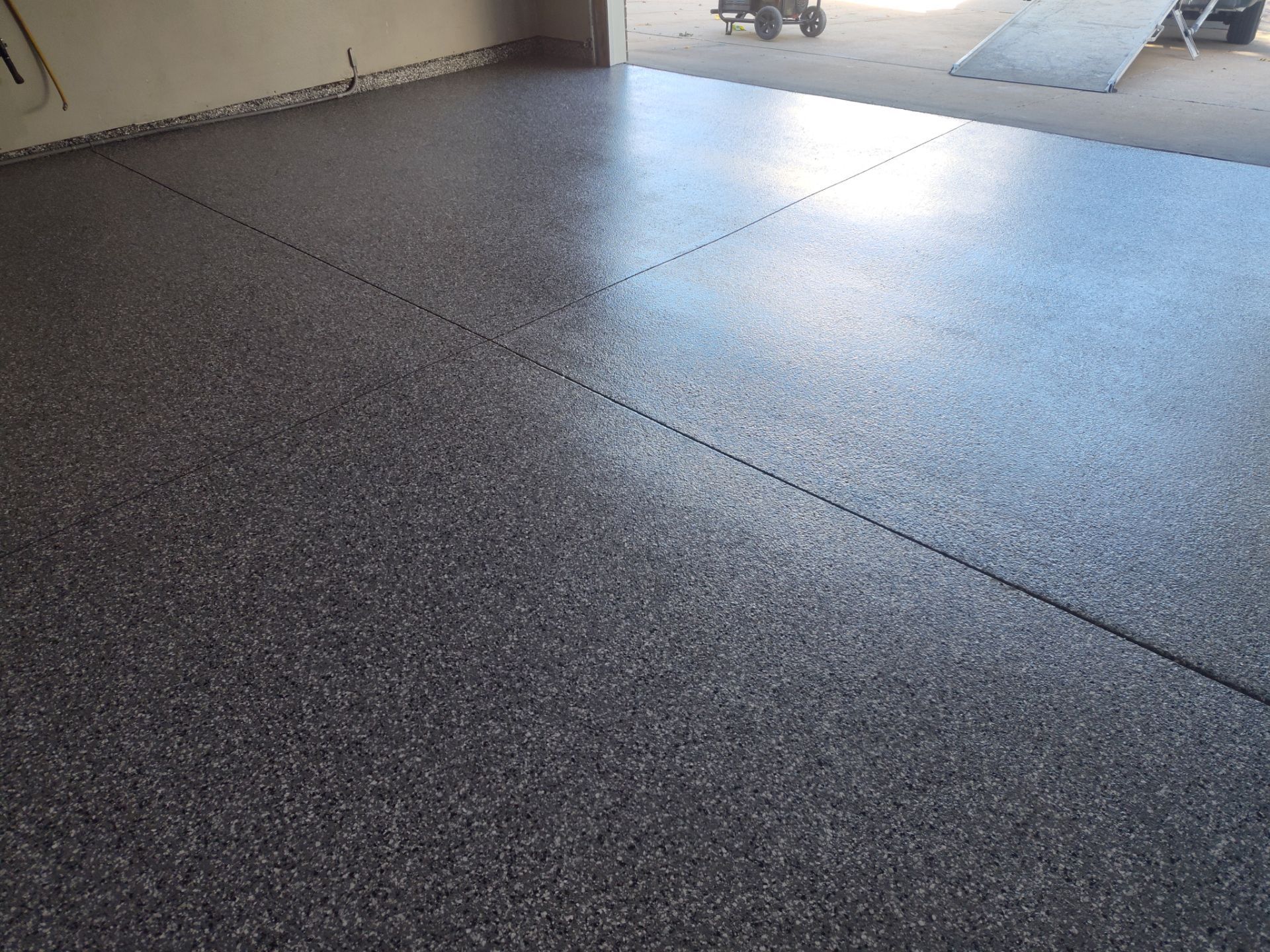 Close Up View of This Customer's New Flake Coating by Revival Concrete Coatings