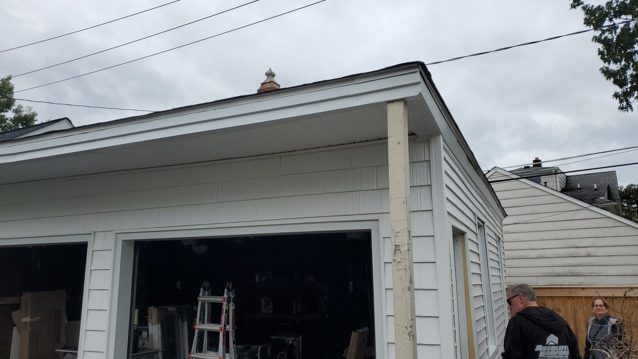 Residential Roofing Installation, Dec-tek walk-out porch roof, siding on garage by Absolute Roofing and Construction