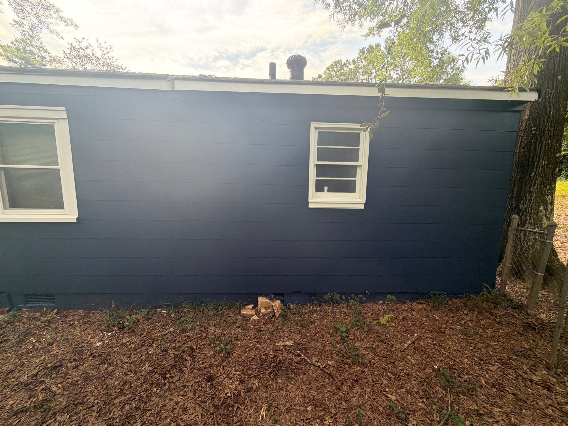 Full Exterior Repaint with Navy Blue and White Trim by Swift Home Renovations