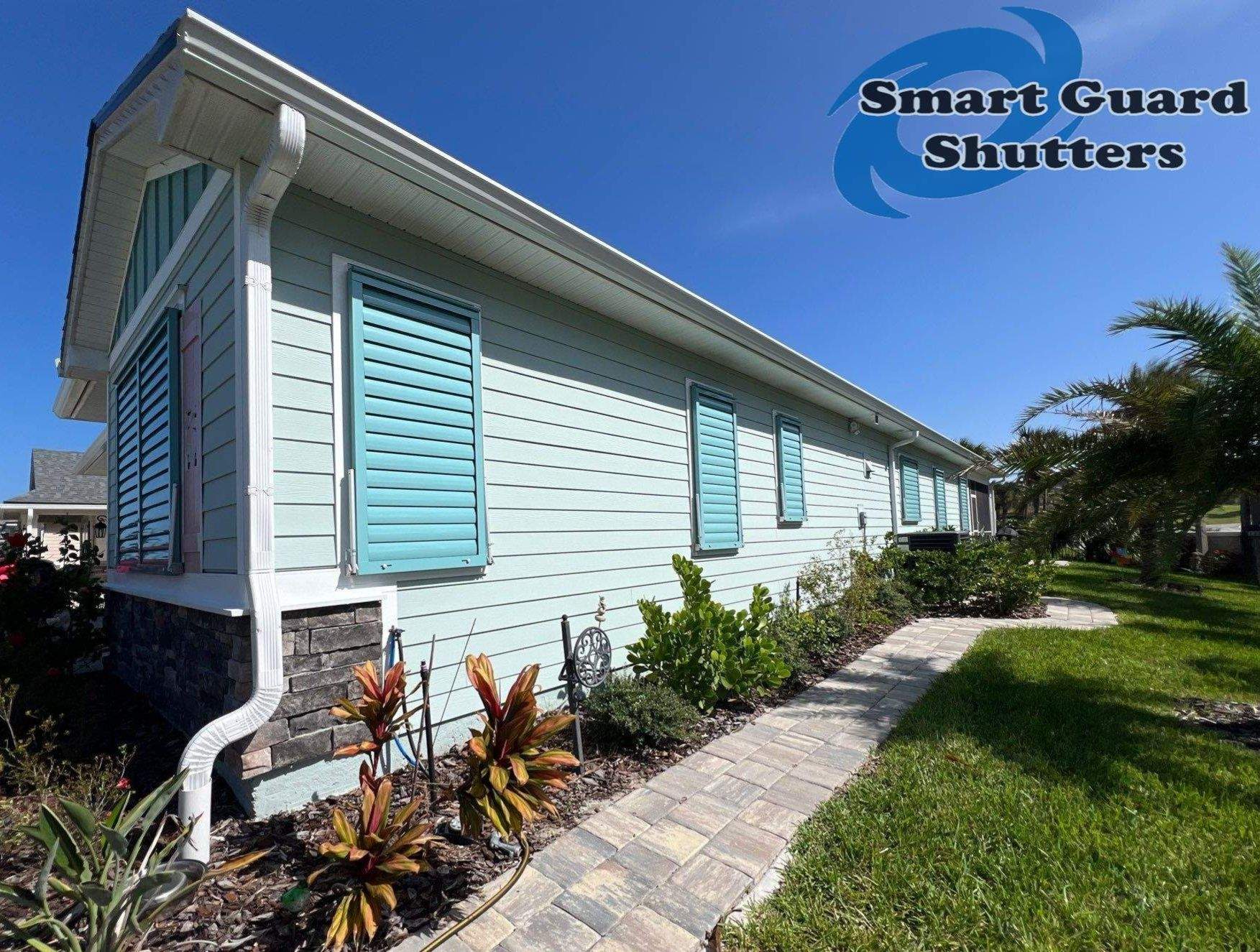 Impact Bahama Shutters in Pastel Turquoise by Smart Guard Shutters