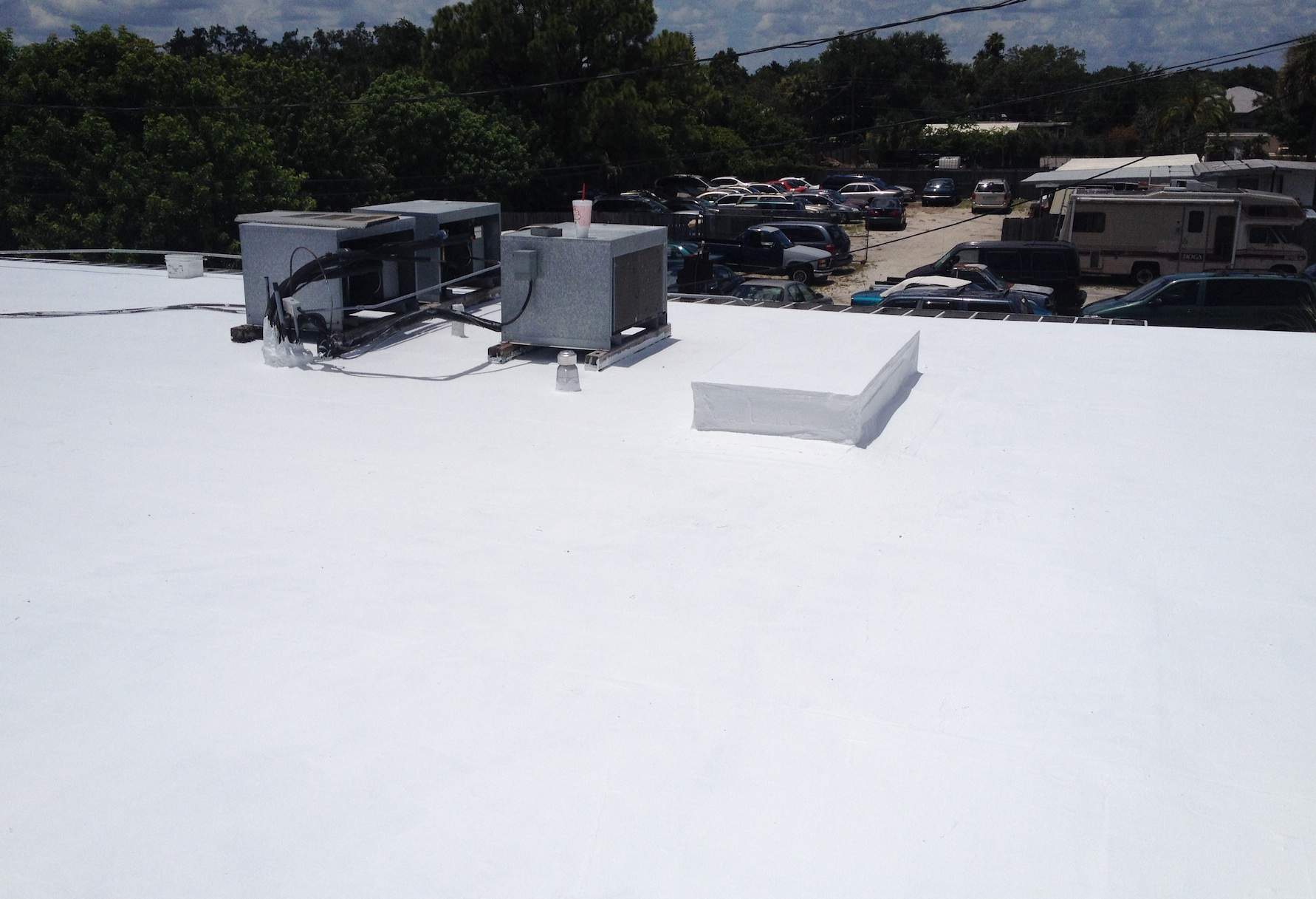 White Reflective Commercial Roof Coating Installation in Melbourne FL by Florida Roofing and Renovations Inc.