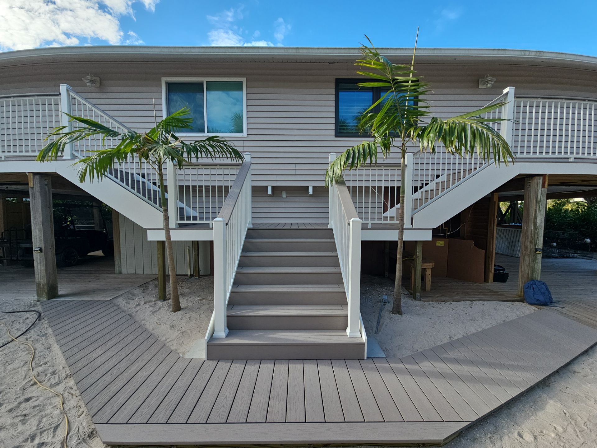 Elevated Home Deck Reconstruction With White Aluminum Railings in Placida by Smirnov Construction Inc