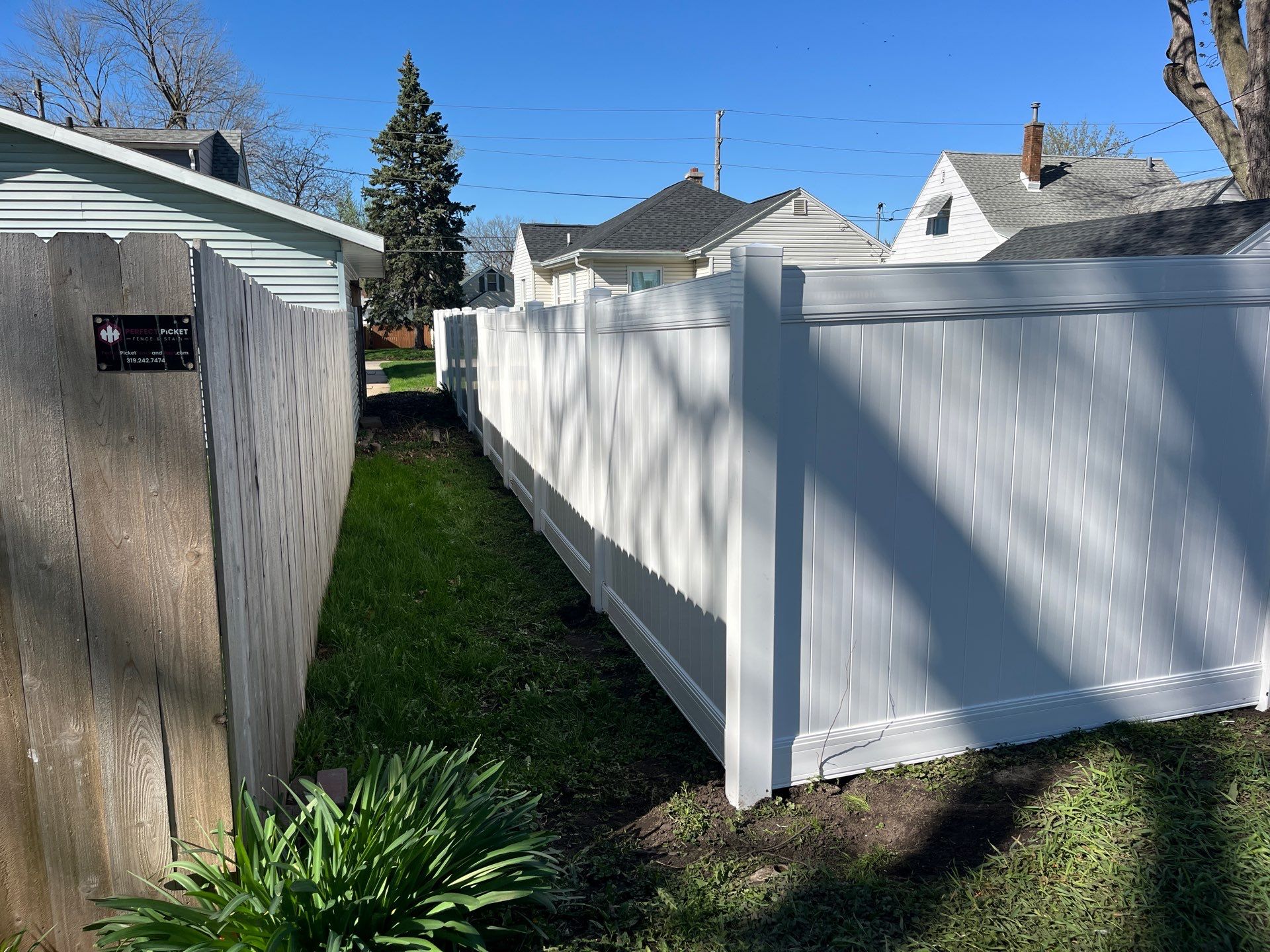 Residential White Vinyl Privacy Fence Installation in Waterloo, Iowa by Perfect Picket Fence and Stain