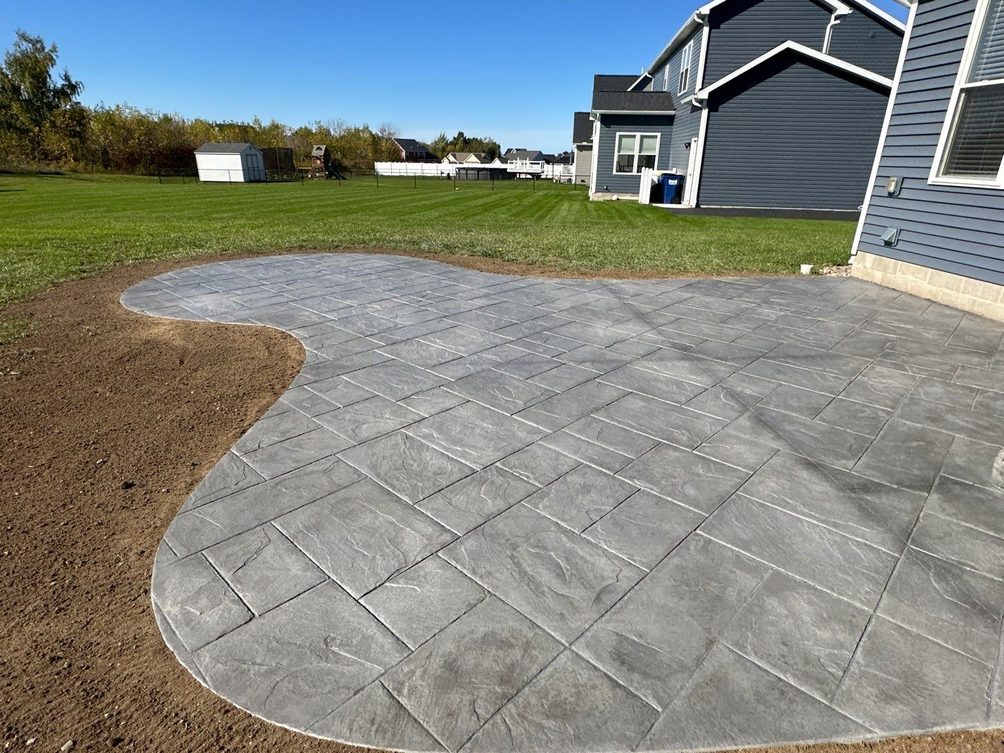 Majestic Ashlar stamped concrete patio with rock face steps  by NG Masonry & Construction LLC