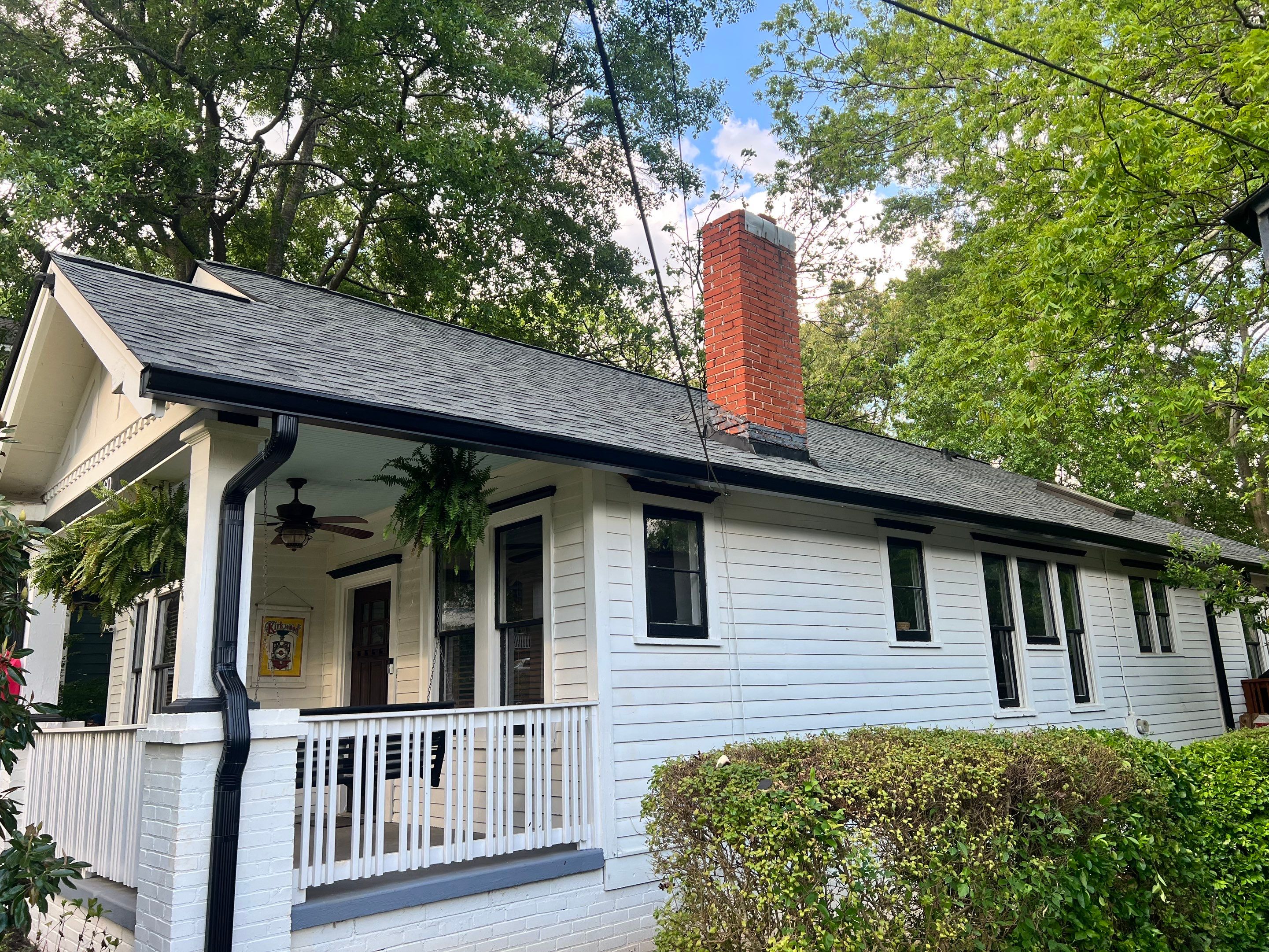 roof replacement and new black gutters by Nailed It Roofing & Remodeling LLC