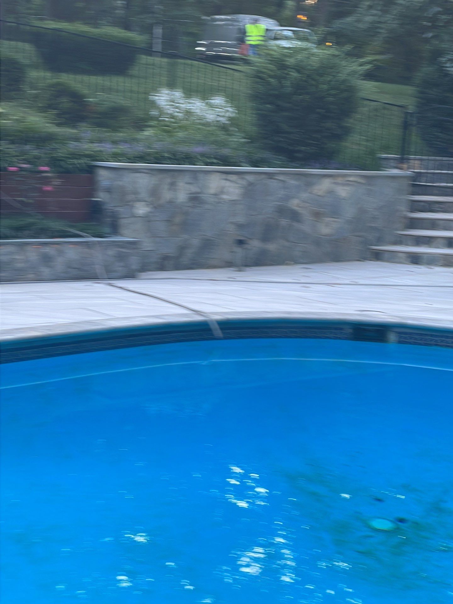 Pool Surround remodel with retaining walls, new waterfall and water slide by Fairfax Contractors, LLC