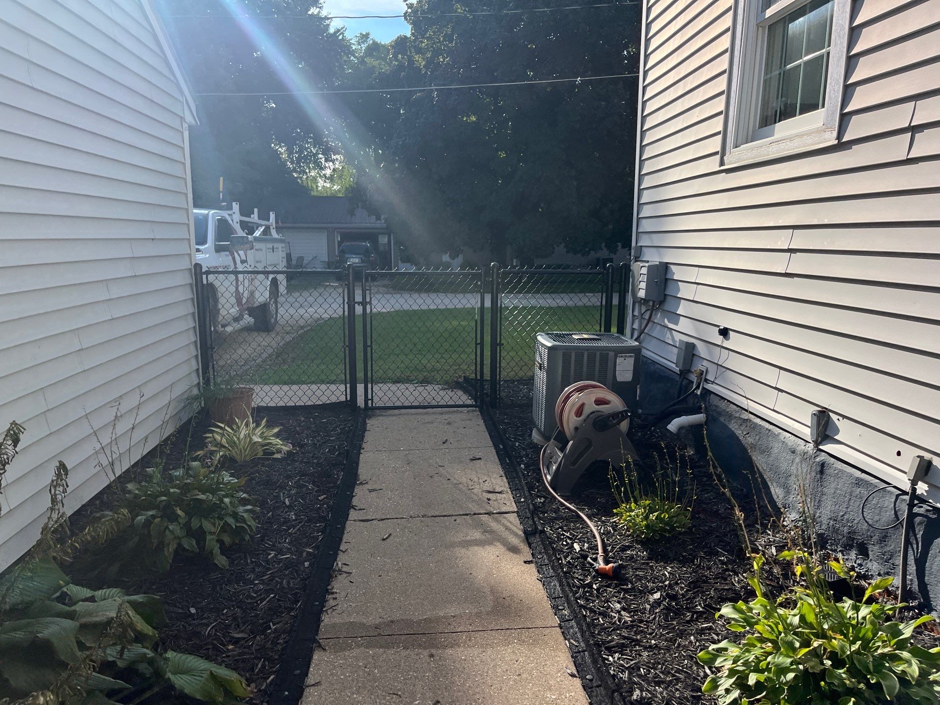 White Vinyl Privacy Fence and Black Chain Link Installation in Sumner by Perfect Picket Fence and Stain