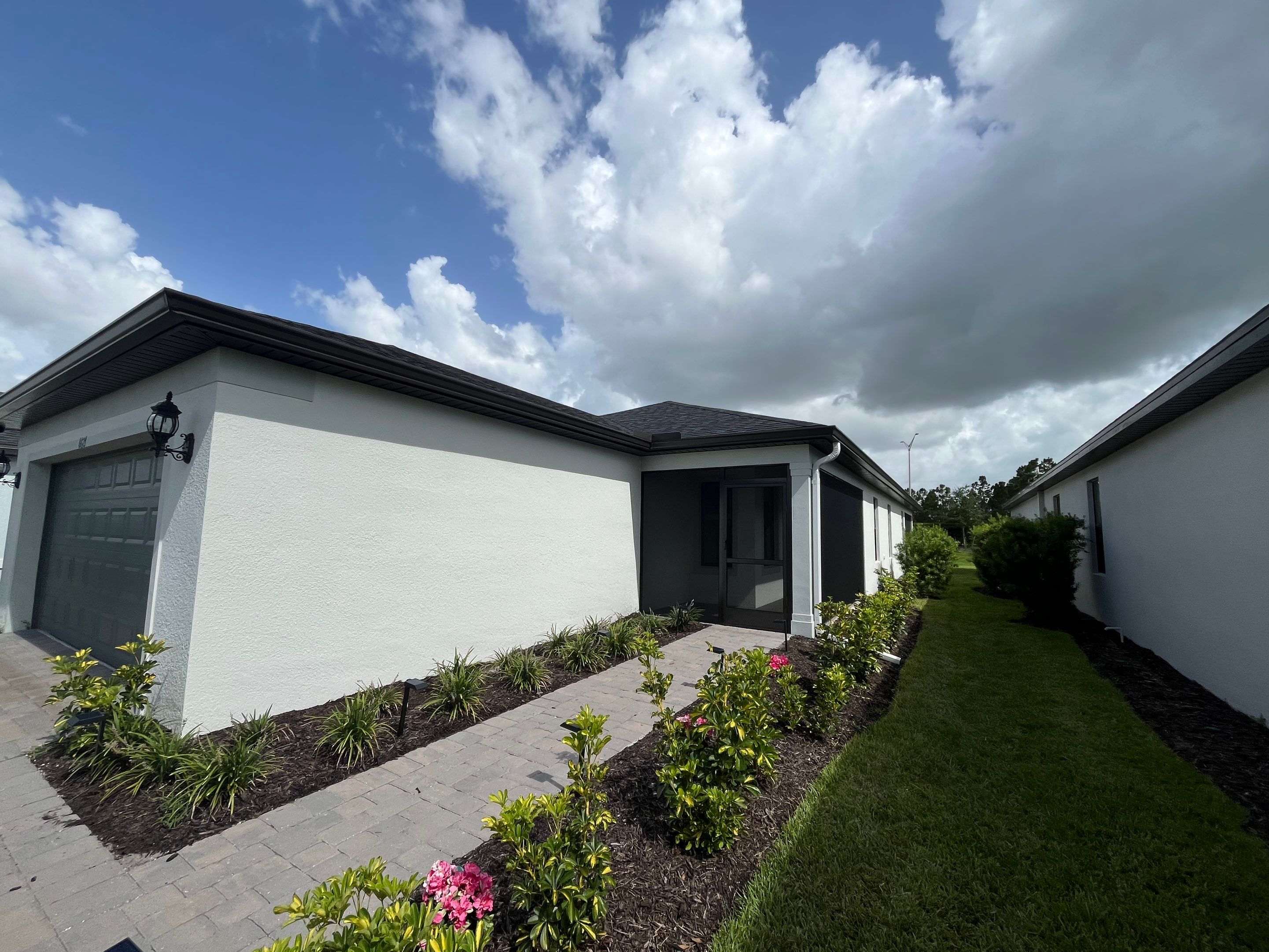 Dark Bronze Gutters and White Downspouts in Sarasota FL by Gutter Professors