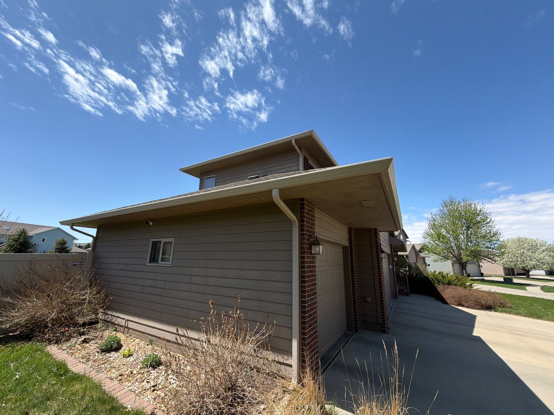 Residential Exterior Painting with Shutter and Trim Updates in Sioux Falls by Select Painting, Coatings & Garage Cabinets