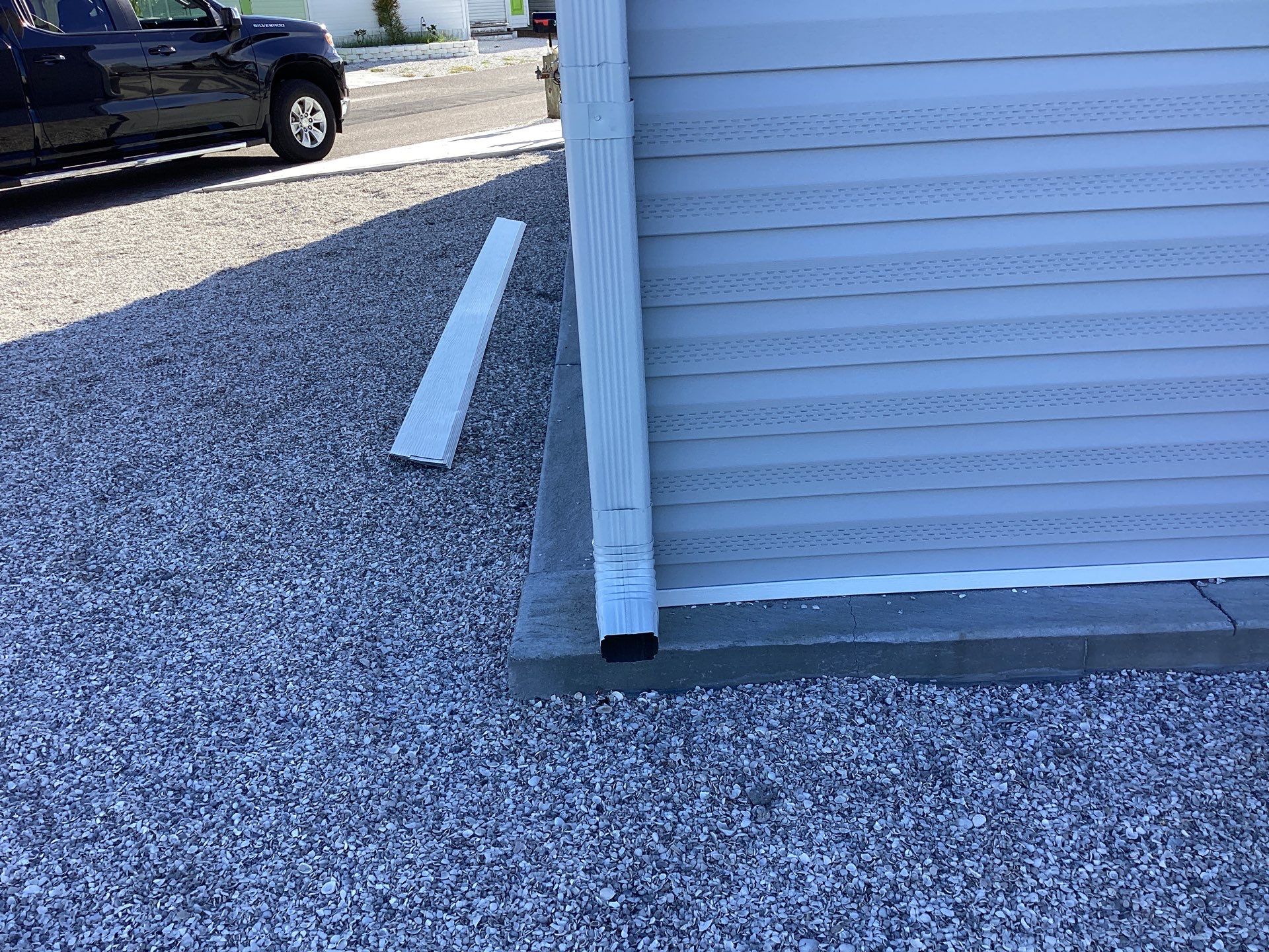 White Downspouts Installation in St. James City by Gutter Professors