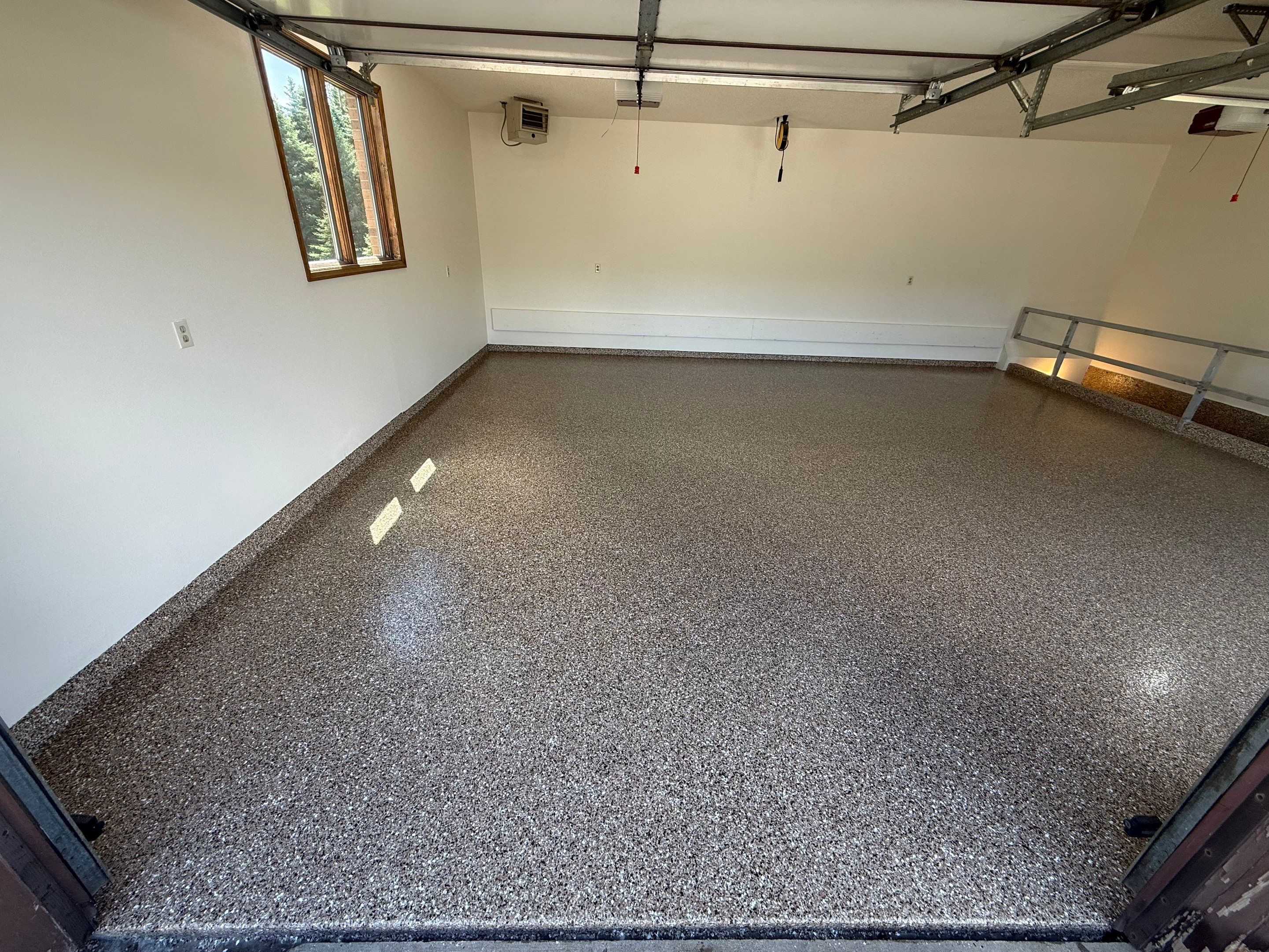 Custom Polyaspartic Garage Floor and Stairwell Coating in Pipestone by Select Painting, Coatings & Garage Cabinets