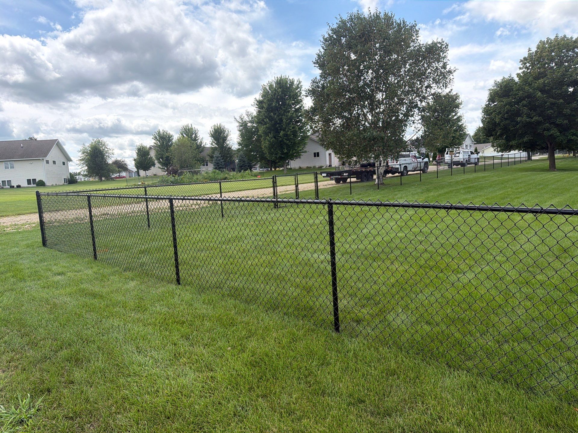 Black Vinyl-Coated Chain Link Fence Installation in Fairbank by Perfect Picket Fence and Stain