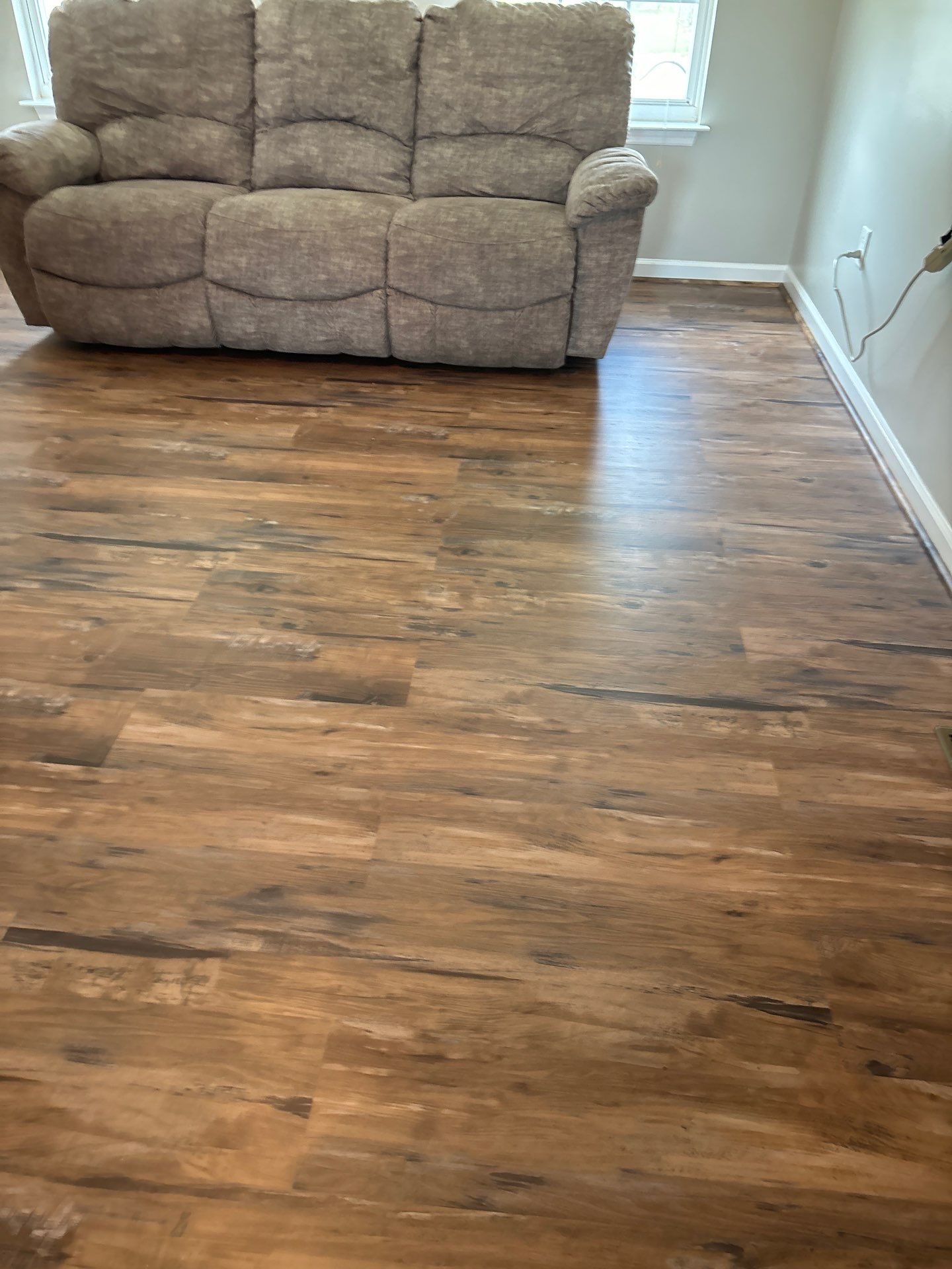 Living room LVP Flooring install  by Laser Focused Solutions LLC