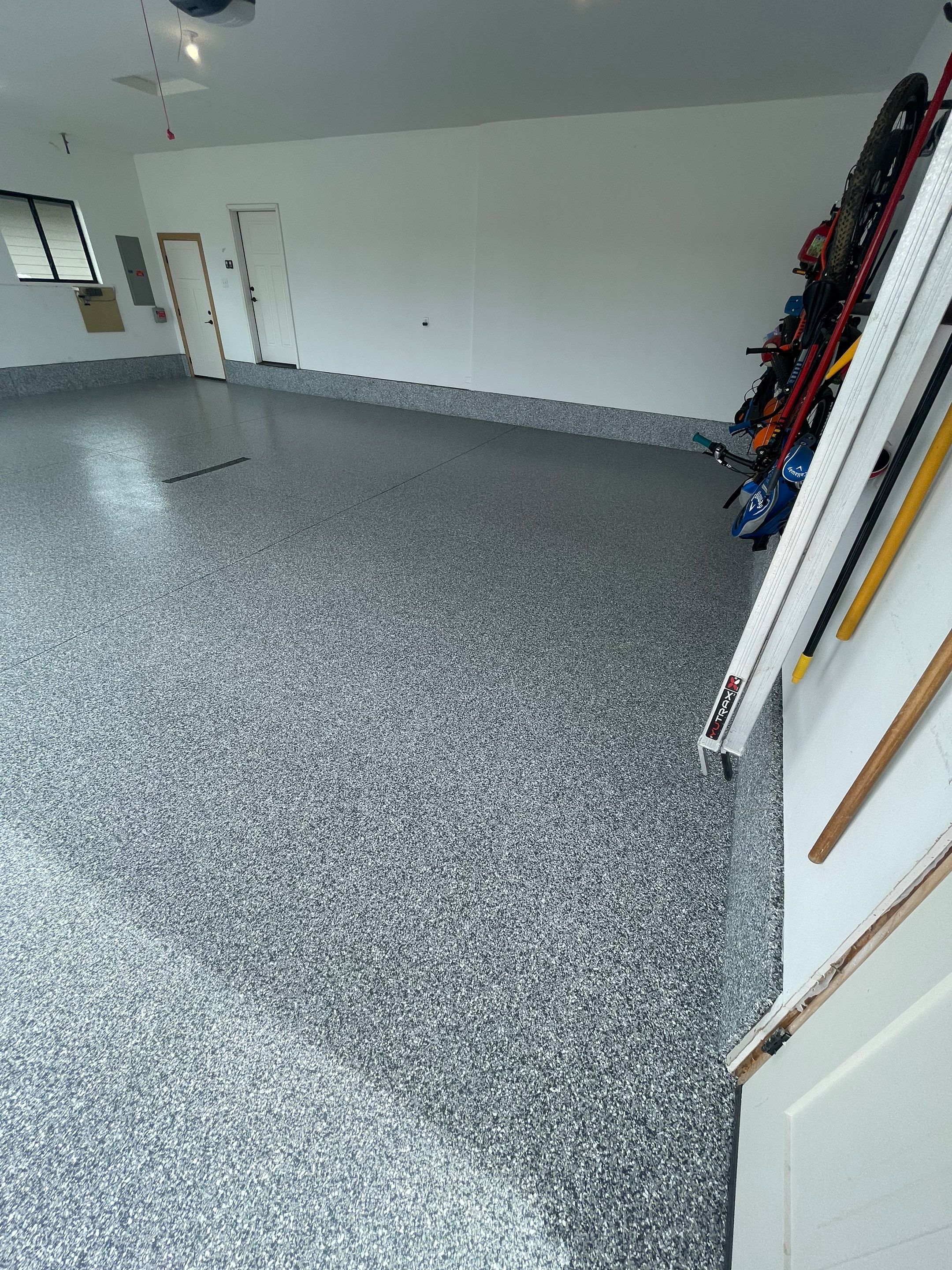 Full Garage Concrete Coating with Grey Speckled Epoxy in Brandon by Select Painting, Coatings & Garage Cabinets