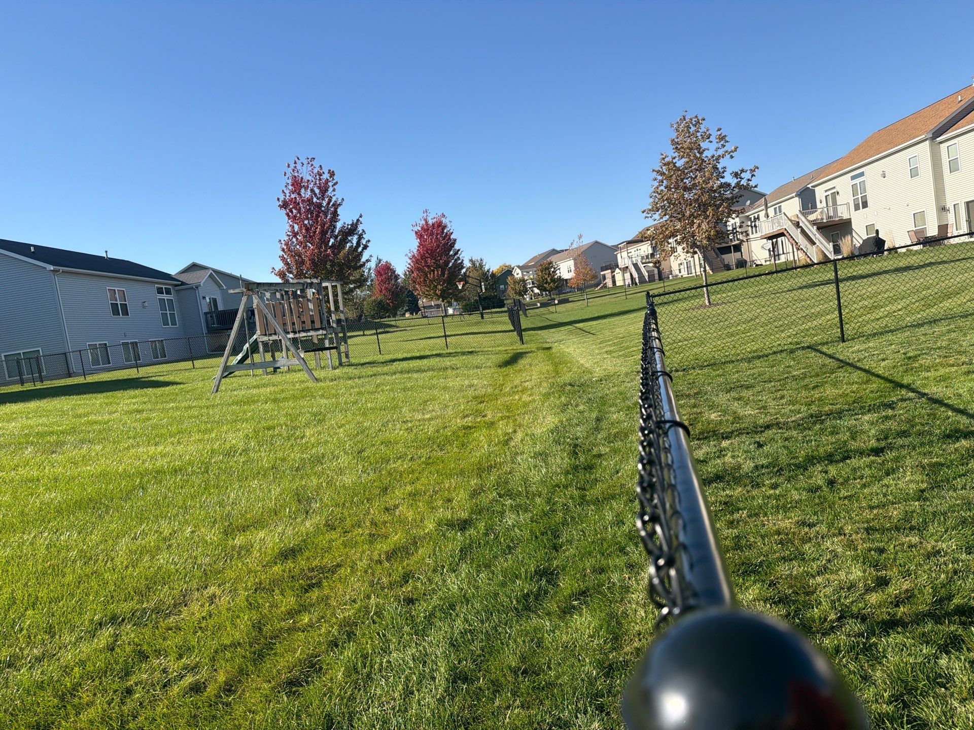 Black Vinyl-Coated Chain Link Fence Installation in Cedar Falls by Perfect Picket Fence and Stain