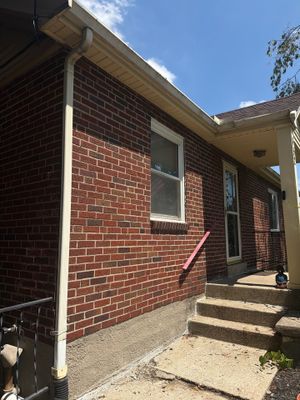 Seamless Black Gutter Installation for Cincinnati Brick Ranch Home