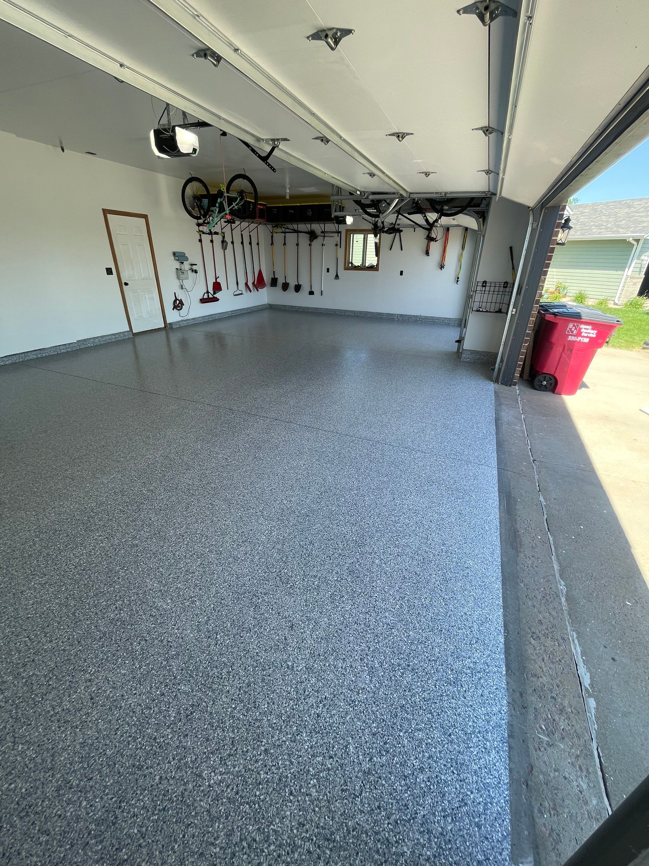 Tidal Wave Flake Garage Floor Installation in Sioux Falls by Select Painting, Coatings & Garage Cabinets