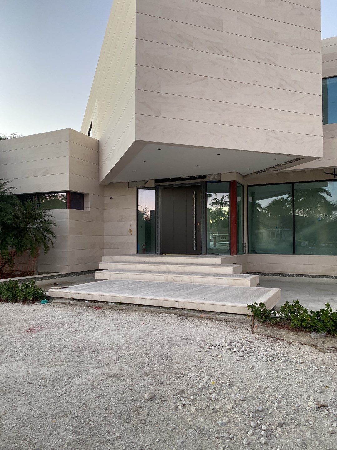 Custom Material Pivot Door installation by Impact Precious Windows and Doors
