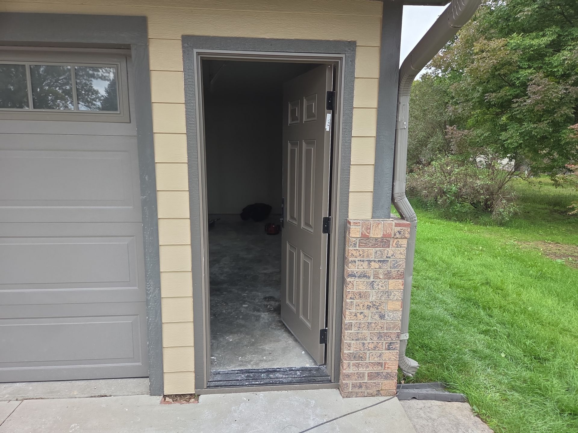 Yankton Garage Remodel with Andersen Window Installation and Drywall by Select Painting, Coatings & Garage Cabinets