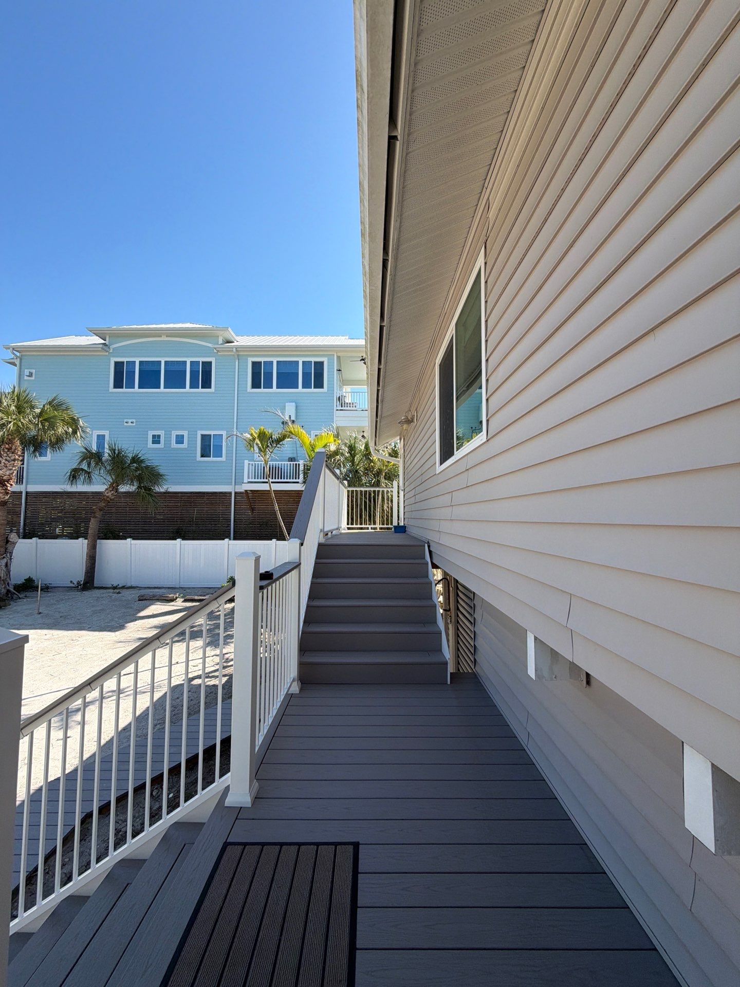 Elevated Coastal Home Renovation with Siding and Custom Decks in Englewood by Smirnov Construction Inc
