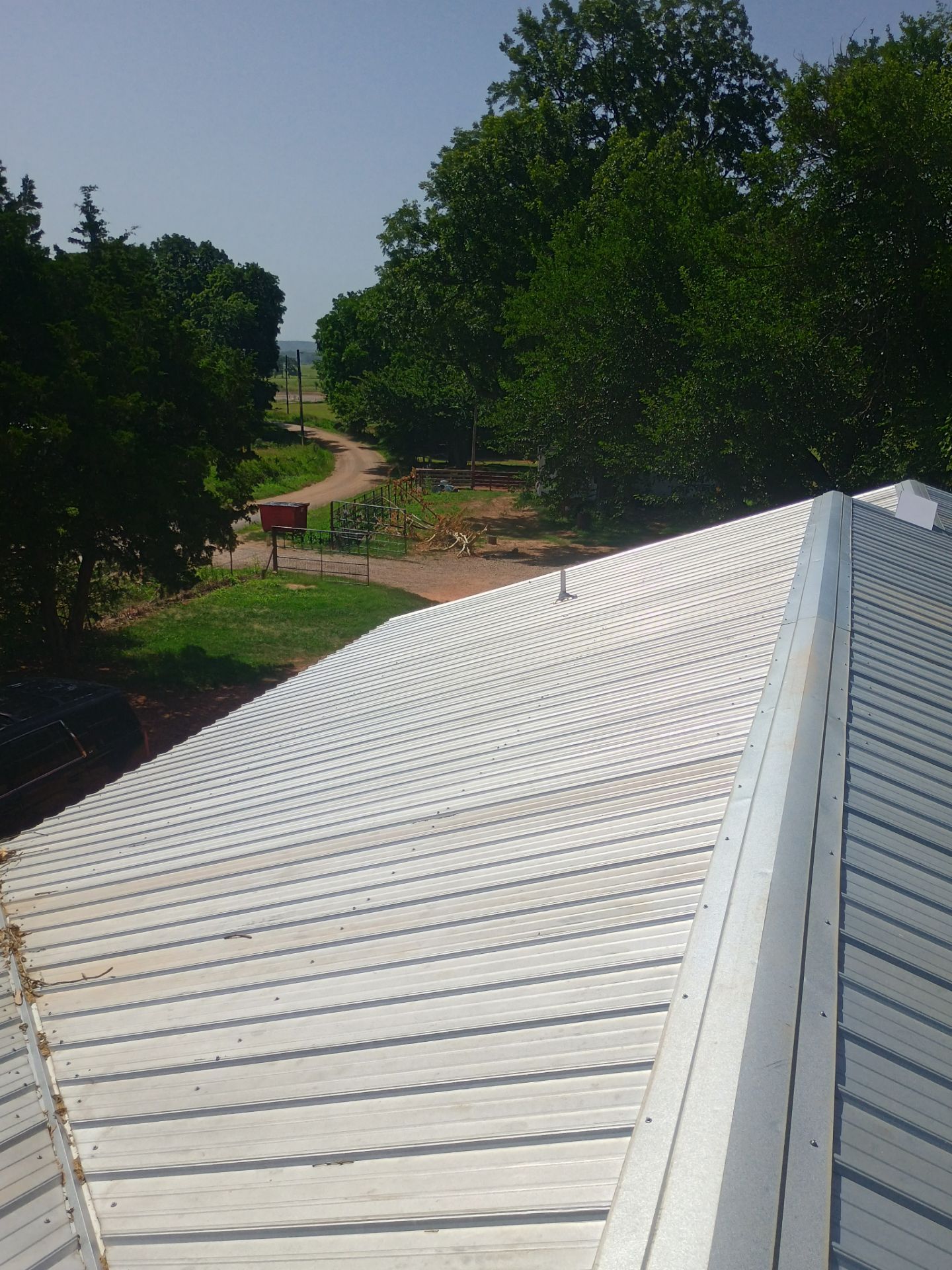 Corrugated Metal Roof Repair for Brick Home in Lindsay by BANA Roofing and Solar Supply
