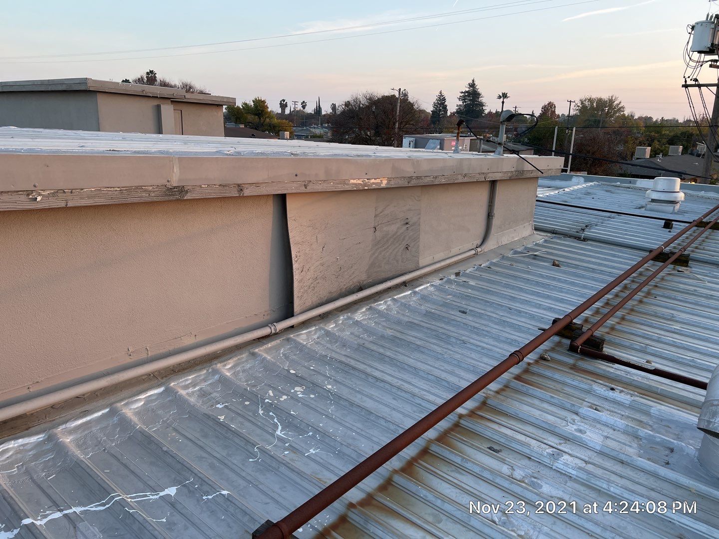 Metal roof restoration on commercial roof using Conklin Benchmark/ PUMA XL acrylic coatings over metal and foam by Straight Edge Roofing Inc