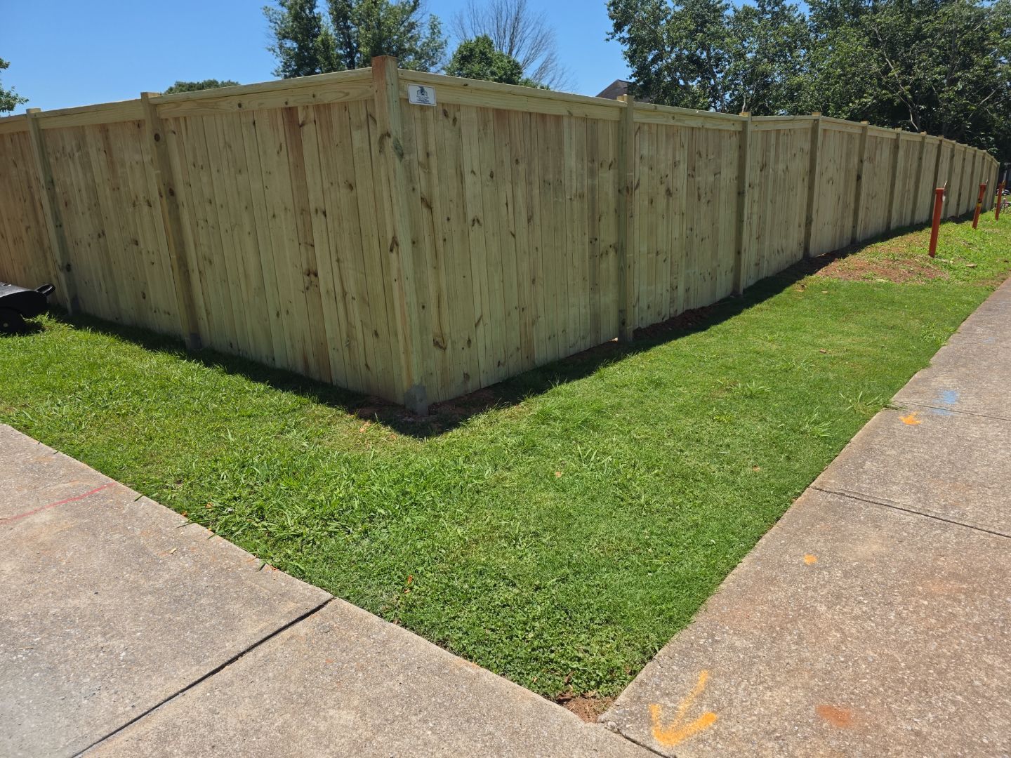 Fence Installation of a Capped Wood Privacy Fence by Titans of Timber Fence & Stain