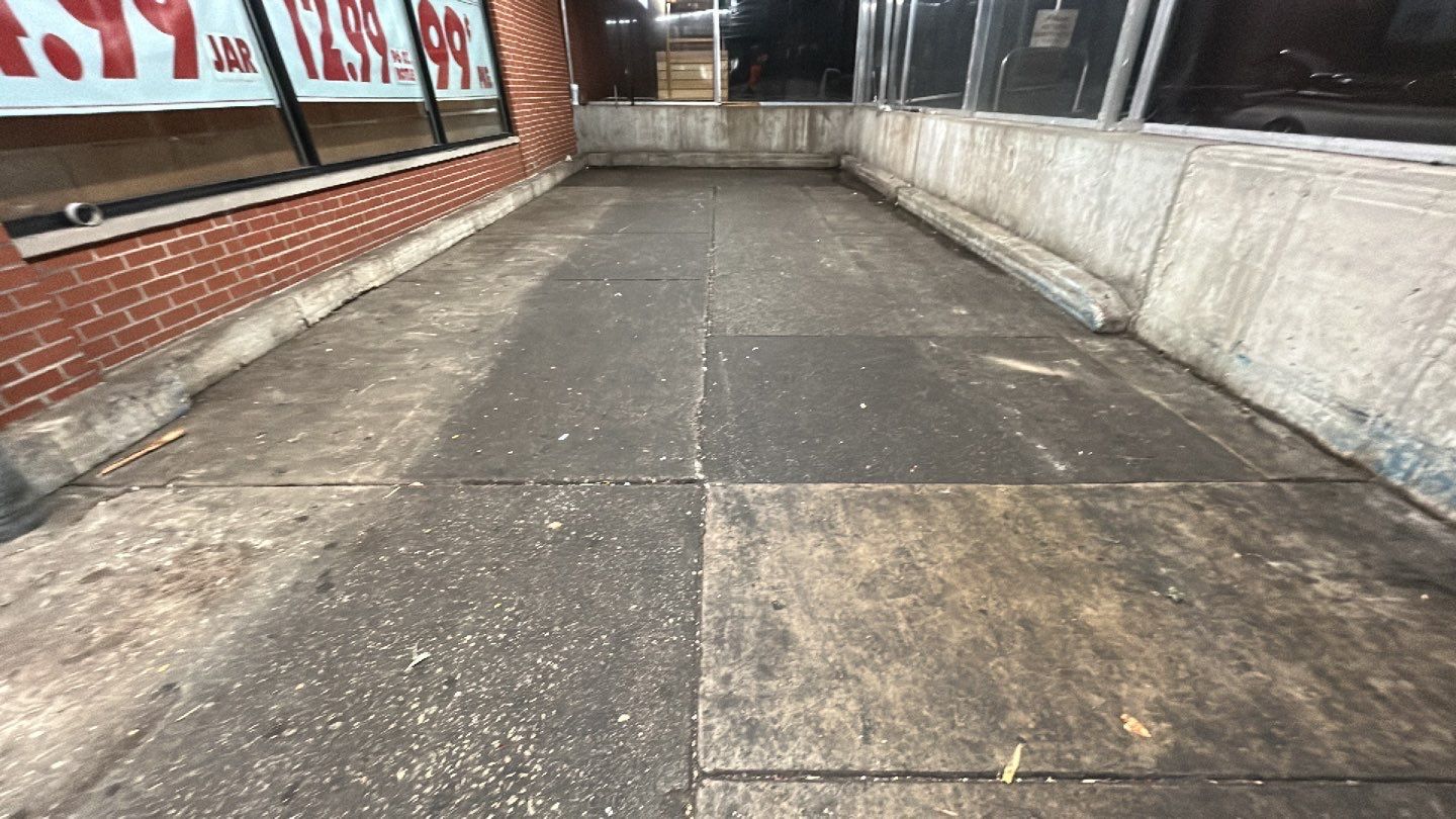 Concrete sidewalk cleaning and degreasing by Northern Power Washing LLC.