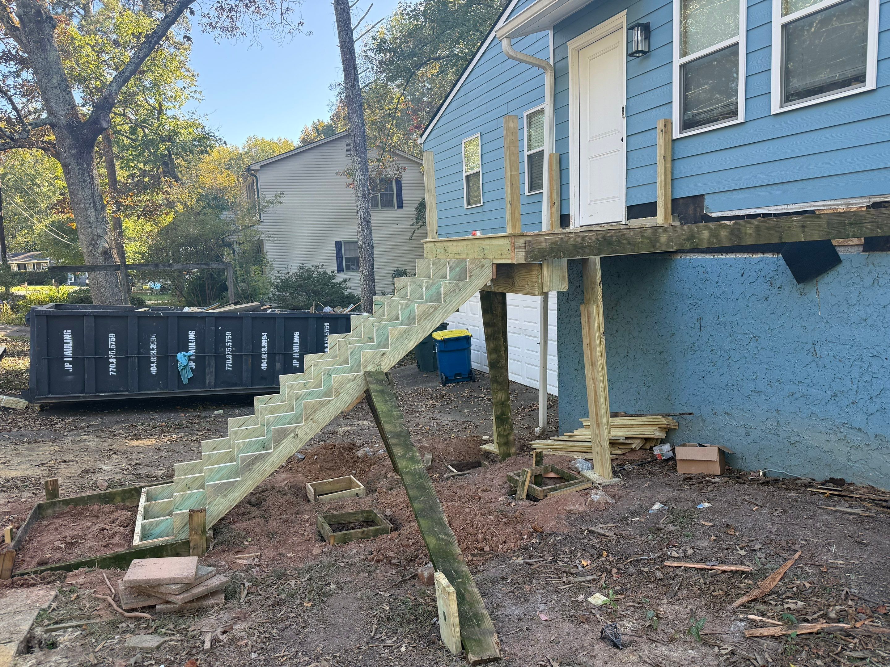 Custom Pressure-Treated Wood Staircase and Landing Installation by Swift Home Renovations