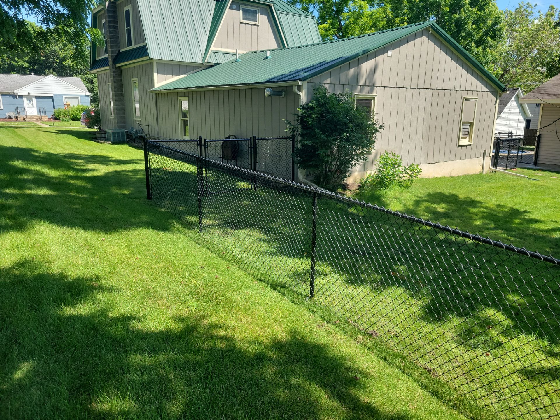 Black Chain Link Perimeter Fence and Driveway Gate in Waverly by Perfect Picket Fence and Stain