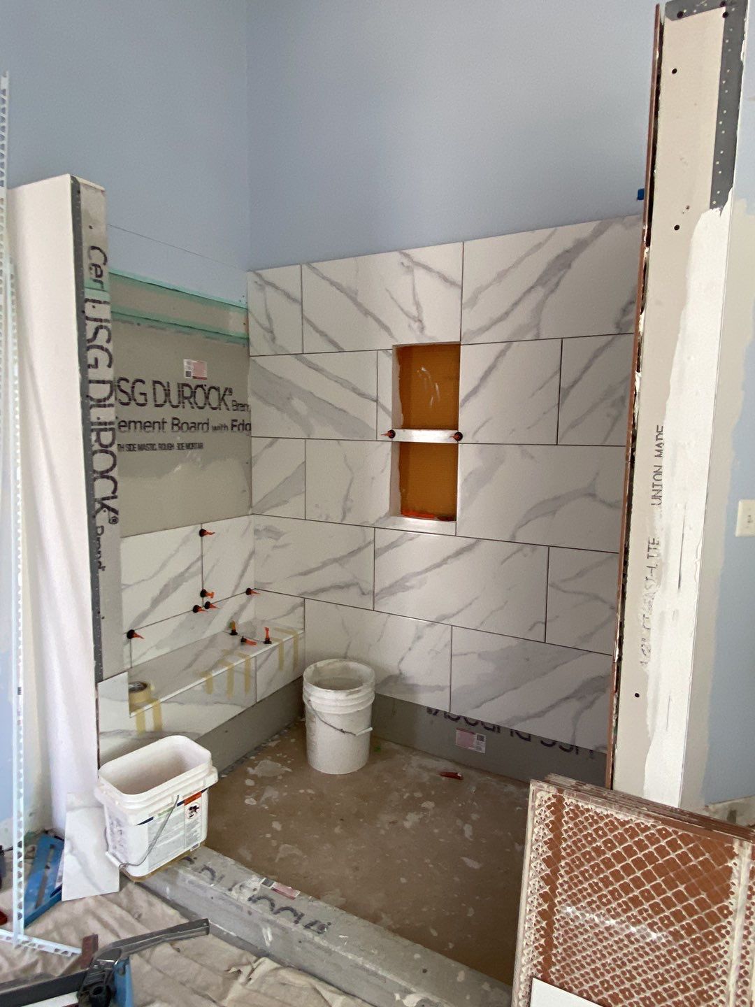 Bathroom Remodel using porcelain tiles , wood make vanetys , mirross , bathroom accessories  by Jesus Master Handyman LLC 