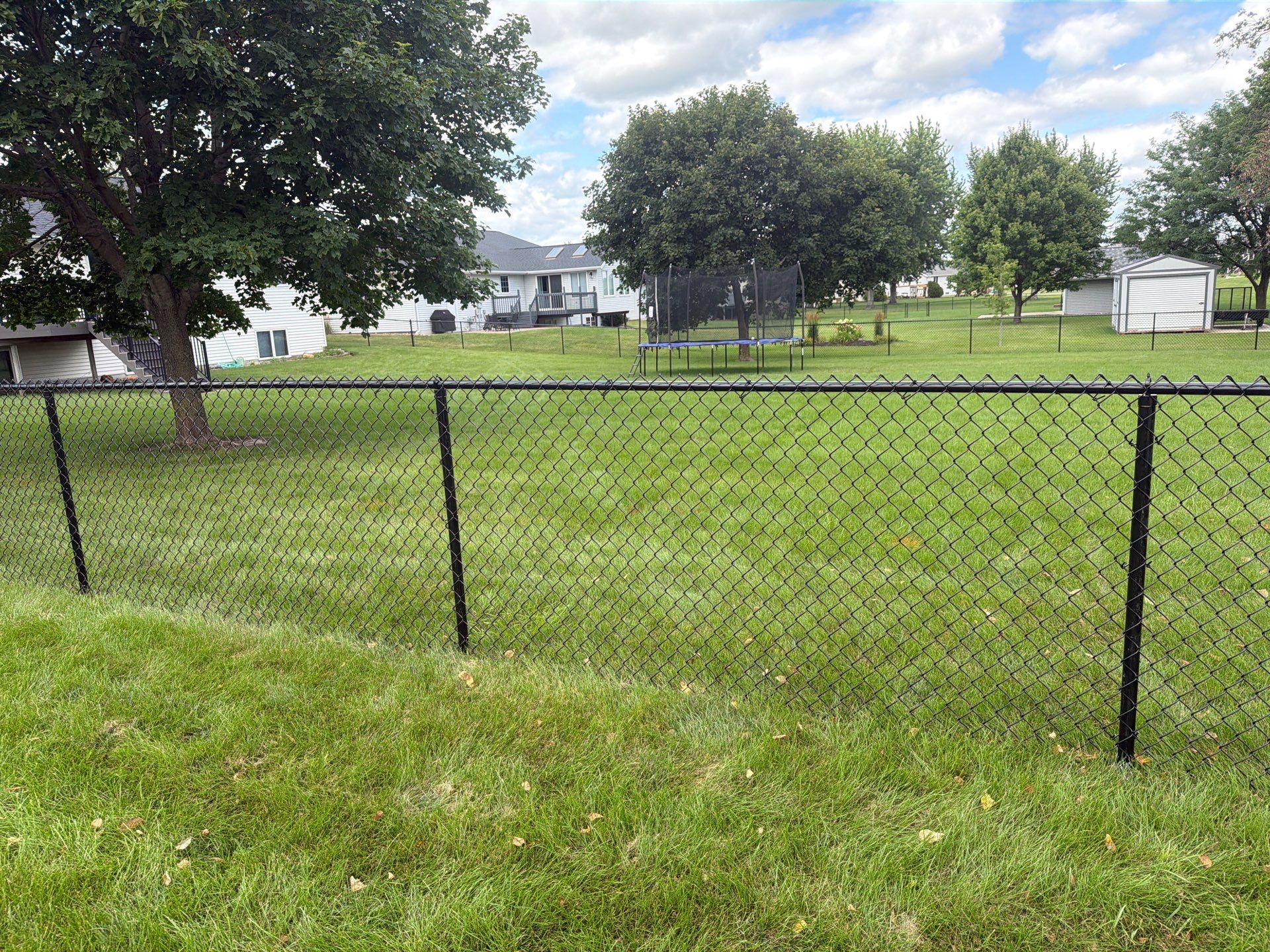 Black Vinyl-Coated Chain Link Fence Installation in Fairbank by Perfect Picket Fence and Stain
