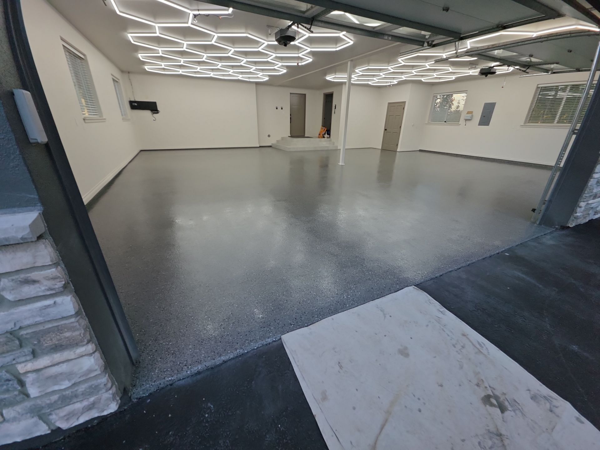 Custom Garage Transformation with Polyaspartic Coating and Hexagonal LED Lighting by Croc Coatings, LLC