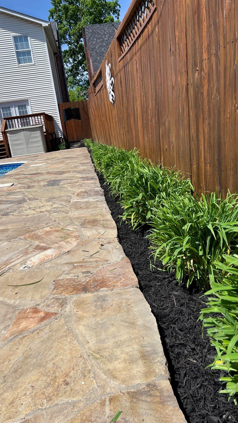 Liriope grasses, mulch and stone pavers by GrassBusters, Inc.