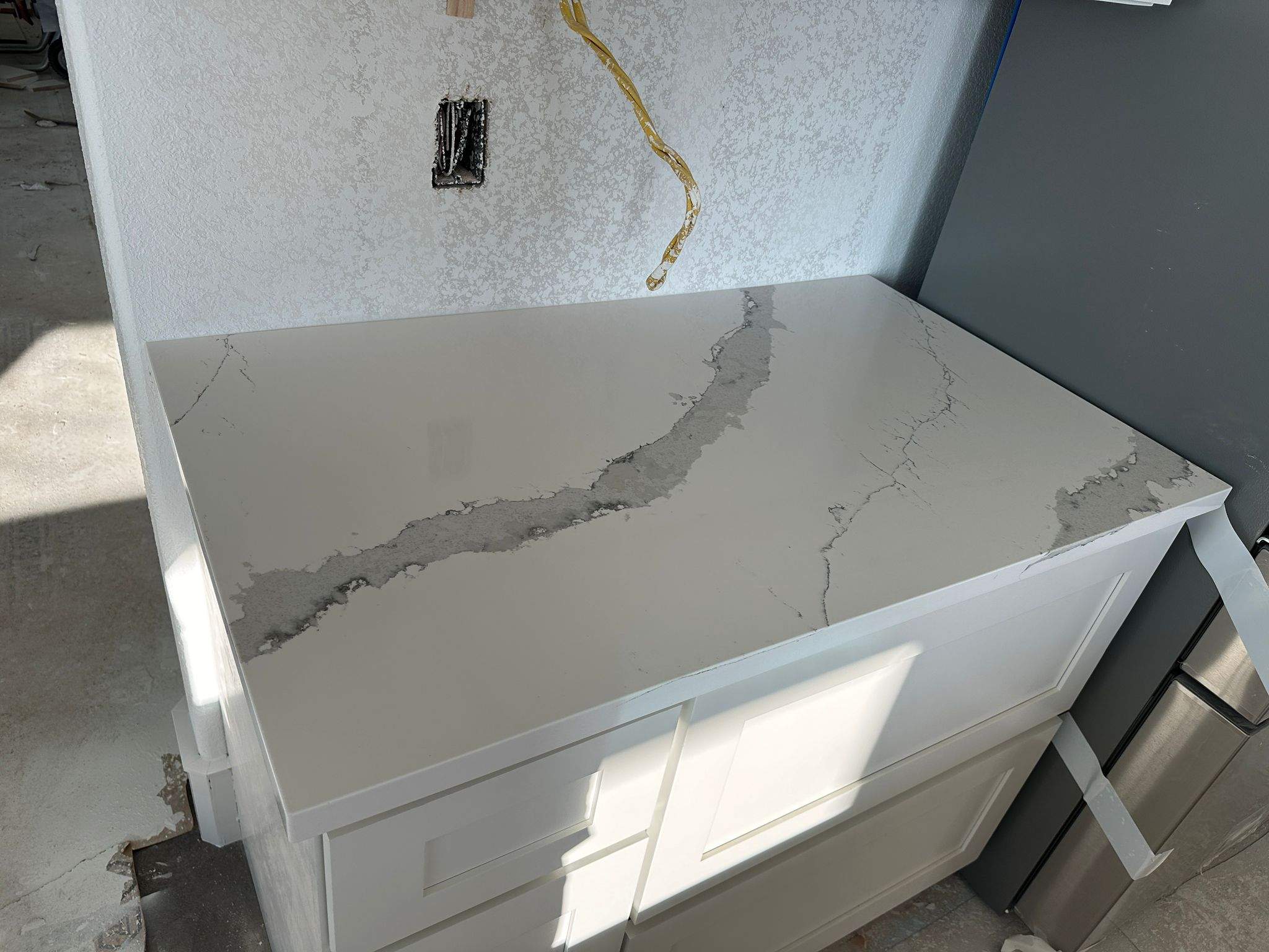 Kitchen and Bathroom Countertop Upgrades Featuring Gray Veined Quartz by Mena stone surfaces