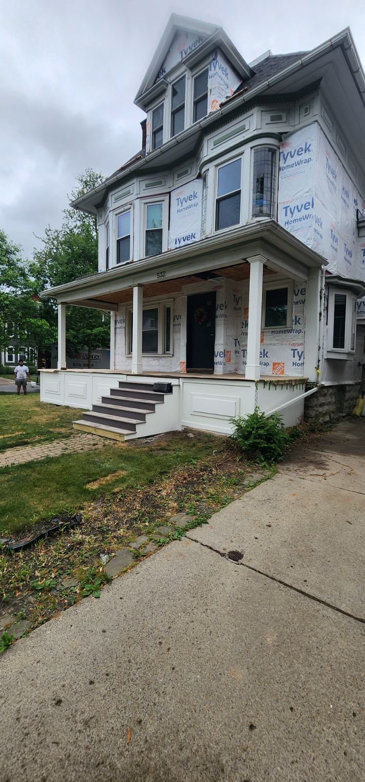 Exterior Renovations- Siding, Stamped Concrete, Porch, and Railings by Ivy Lea Construction