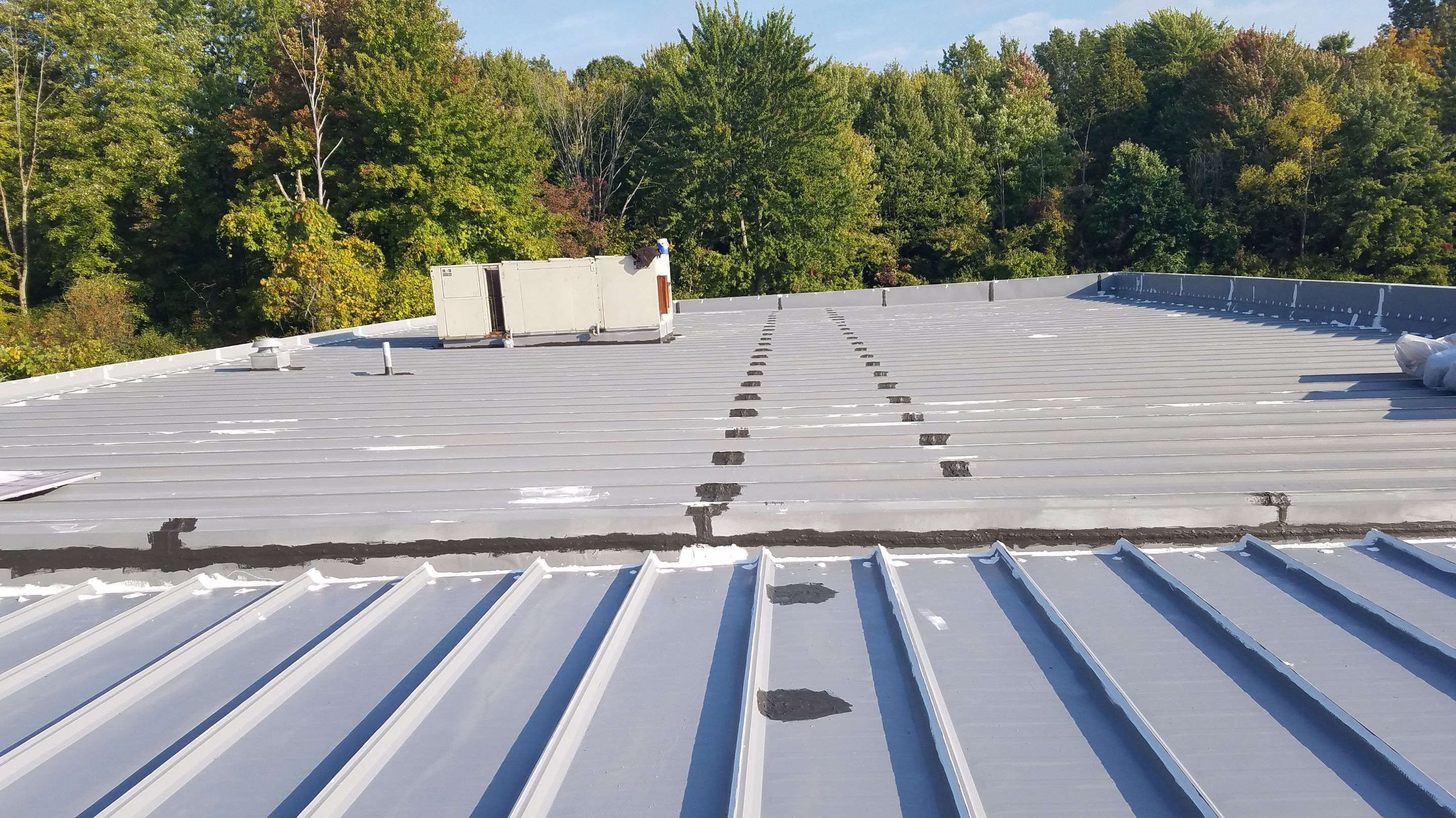 Commercial Metal Roof Coating by Gold Star Roofing LLC