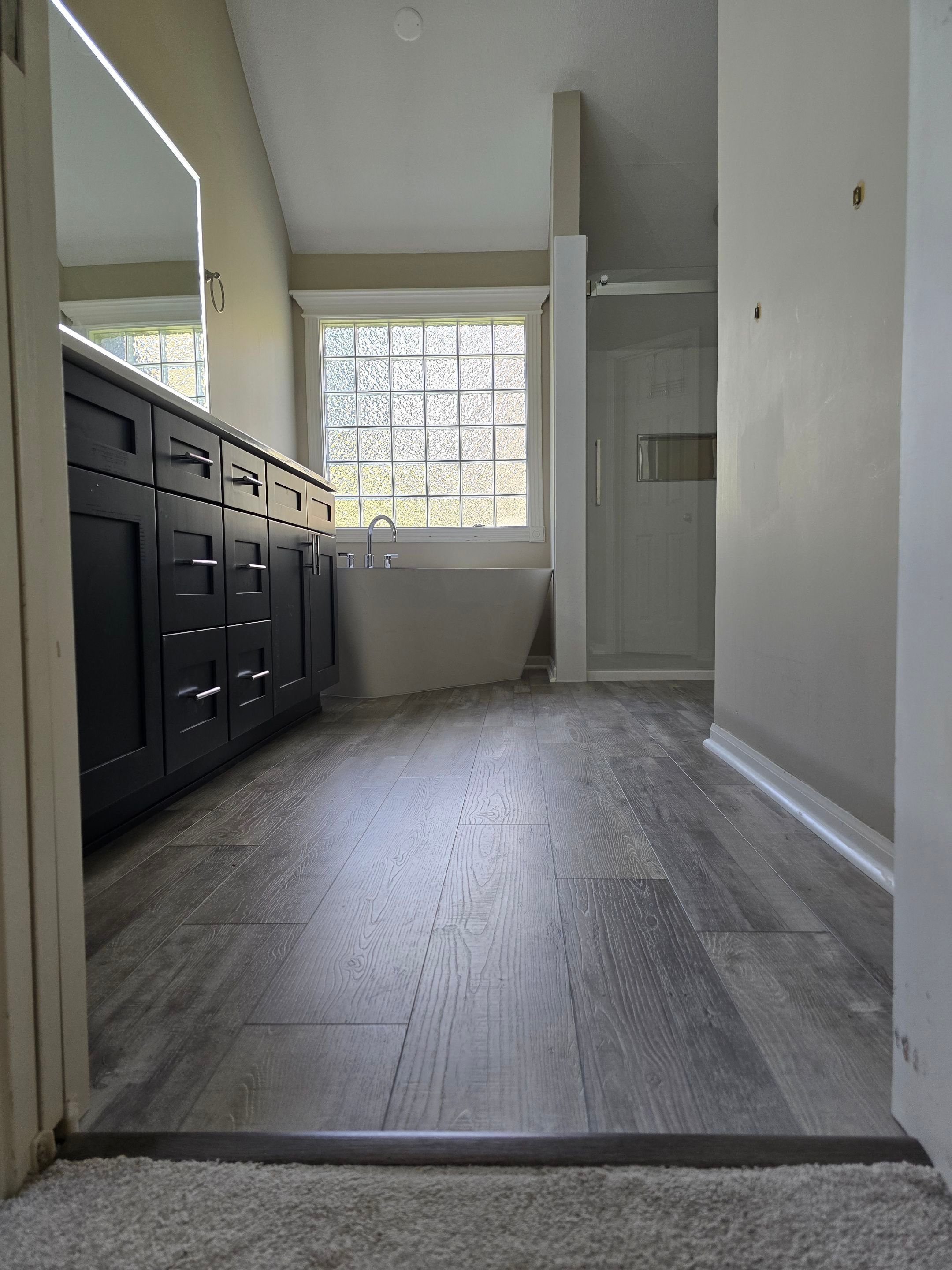 Full bathroom remodel with Artus lighted mirrors, Waltz bathtub and Mercury doors by The Shower Company