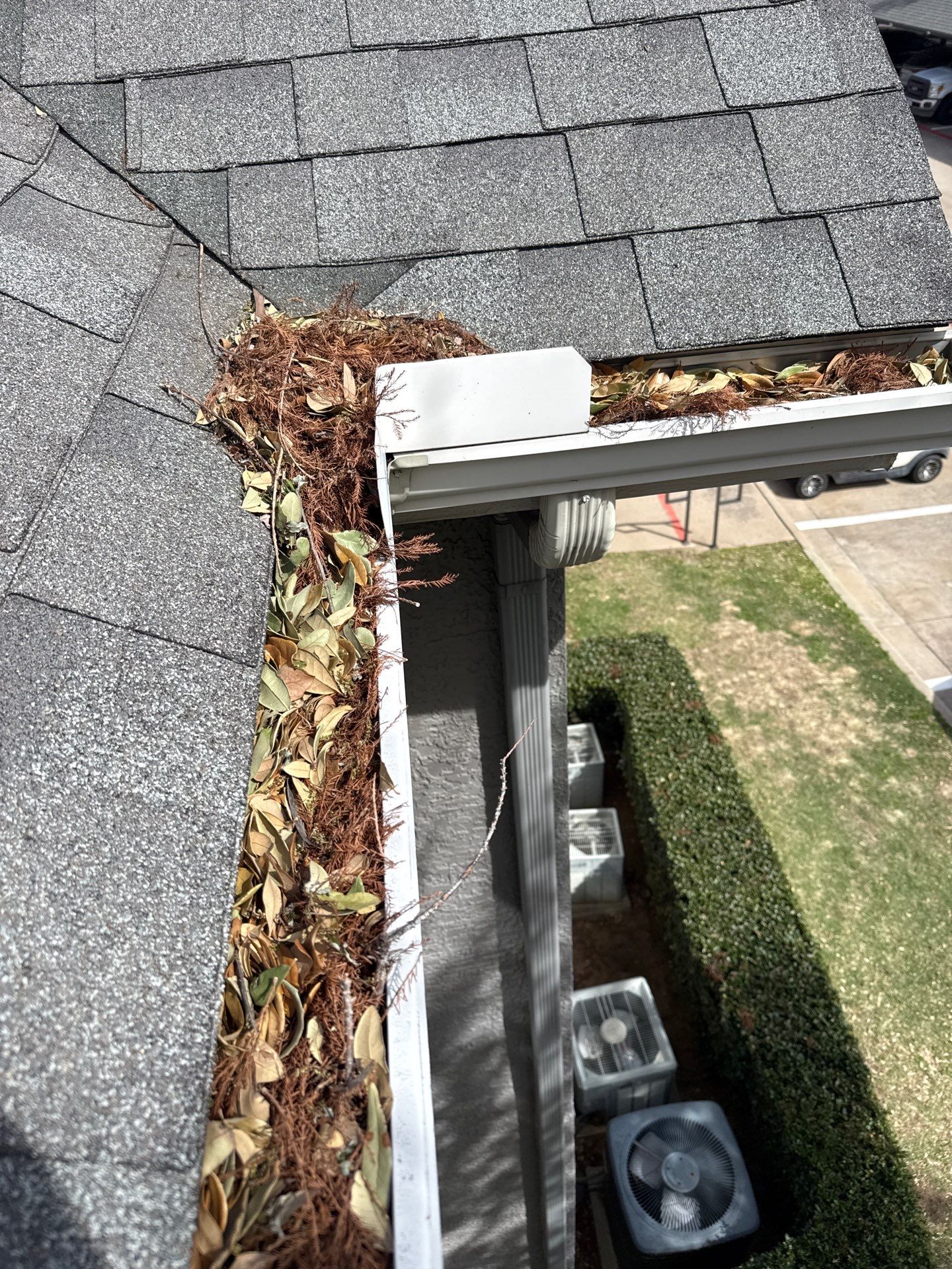 HOA gutter cleaning in Flower Mound & Lewisville,before  photo showing full gutters.