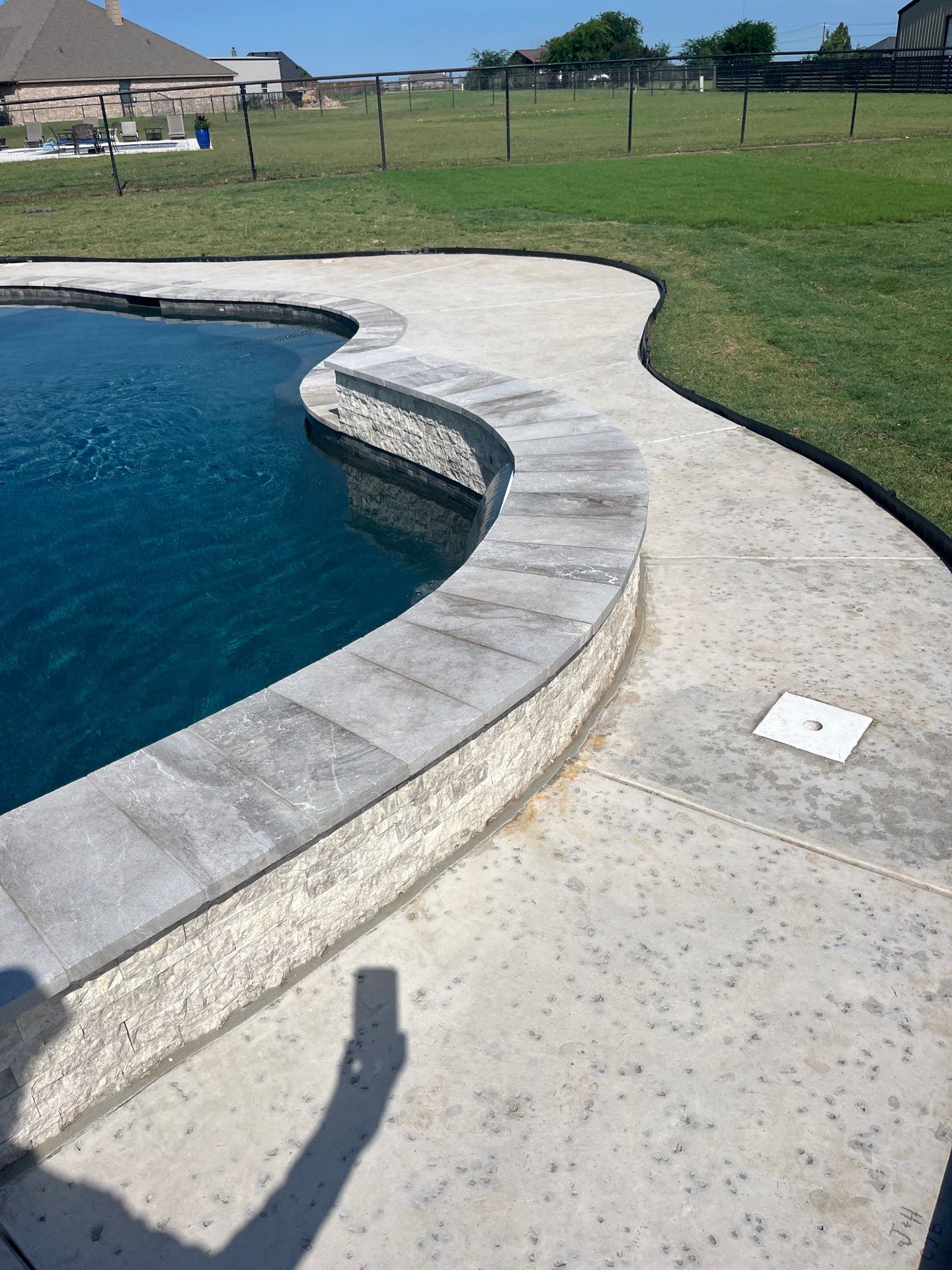 Freeform Pool with Raised Stone Spa Wall by Pinnacle Pools and Spas - DFW