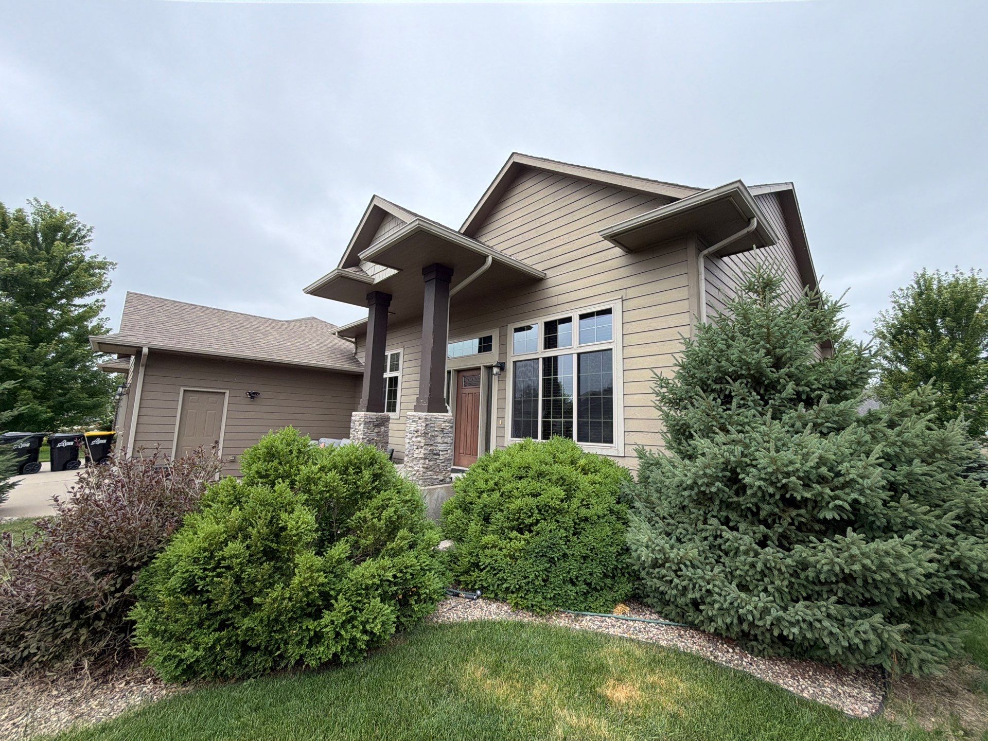 Full Exterior Siding Repaint for Sioux Falls Home and Garage by Select Painting, Coatings & Garage Cabinets