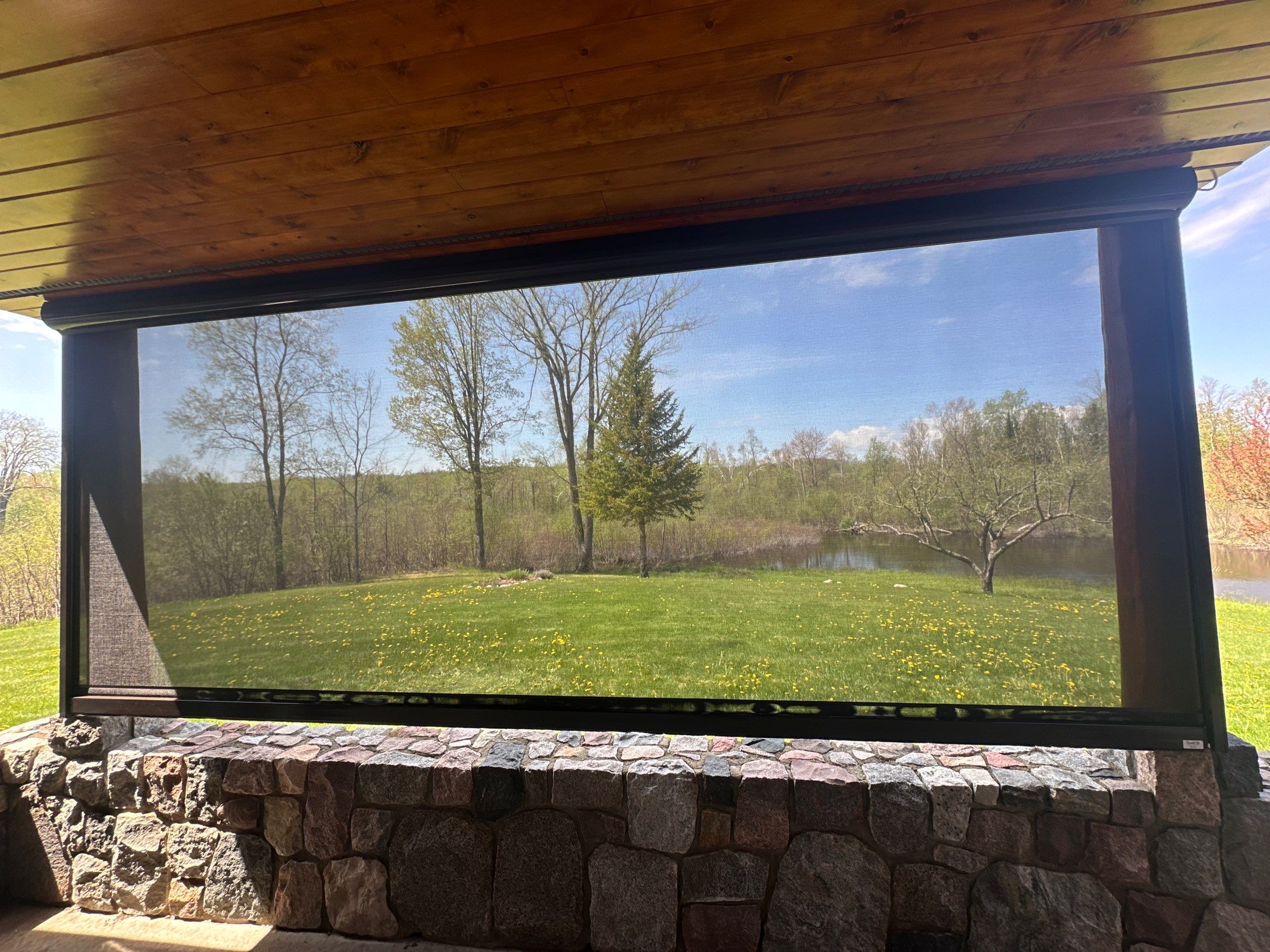 Sunesta Retractable Screen Installation on a Petoskey Log Home Porch by Rainbow Seamless Systems