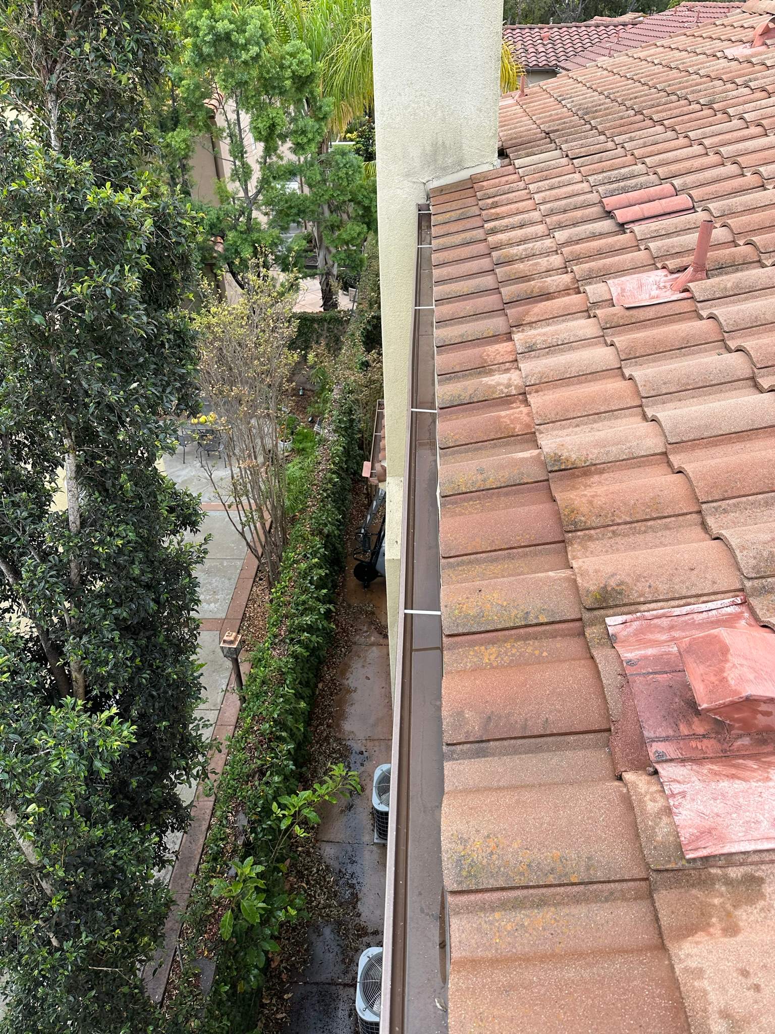 Clogged gutters at this Irvine home in Woodbury by Property Cleaning Experts, LLC