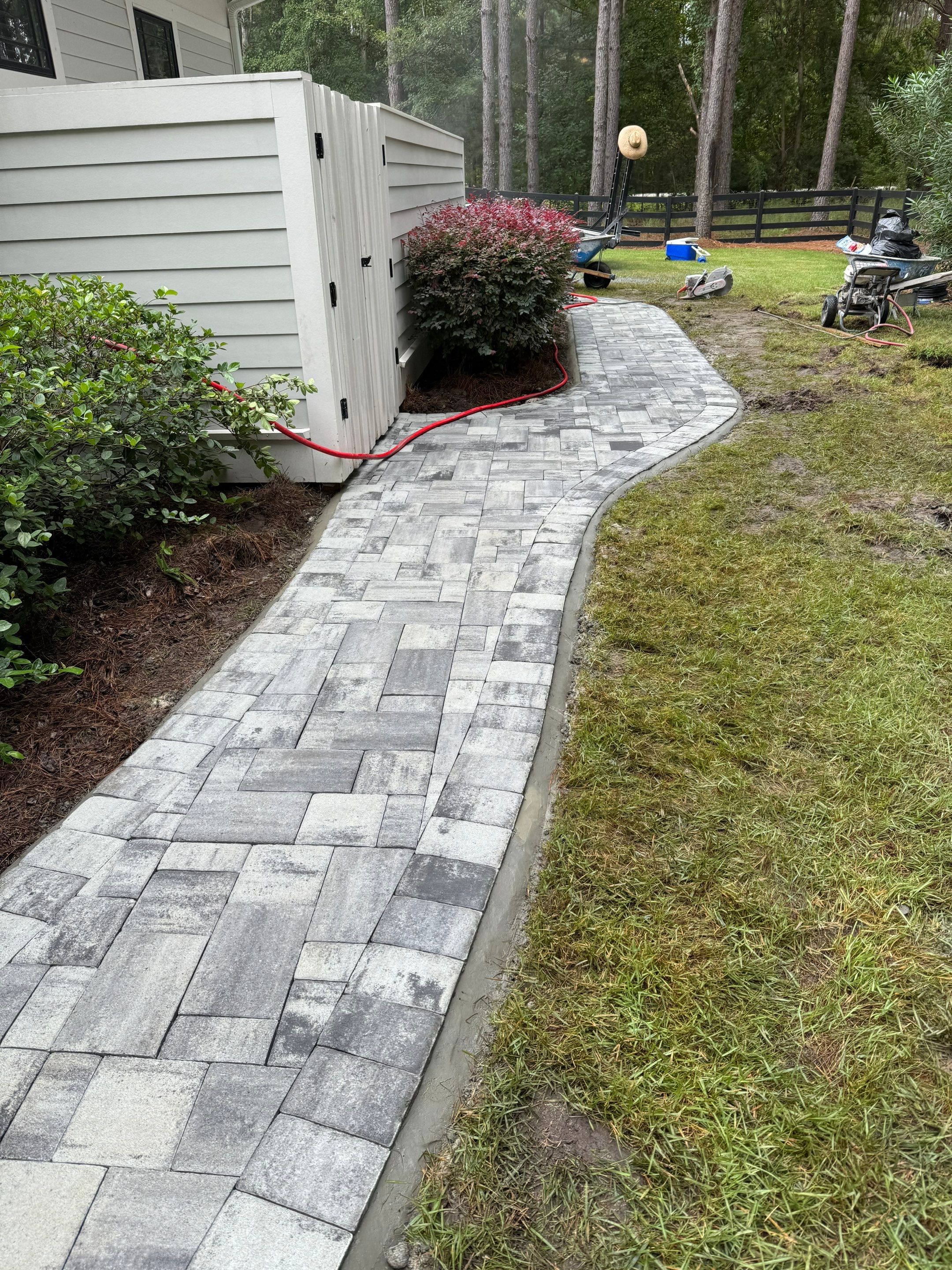 Curved Gray Paver Walkway Installation in Bluffton by Lowcountry Scapes, LLC