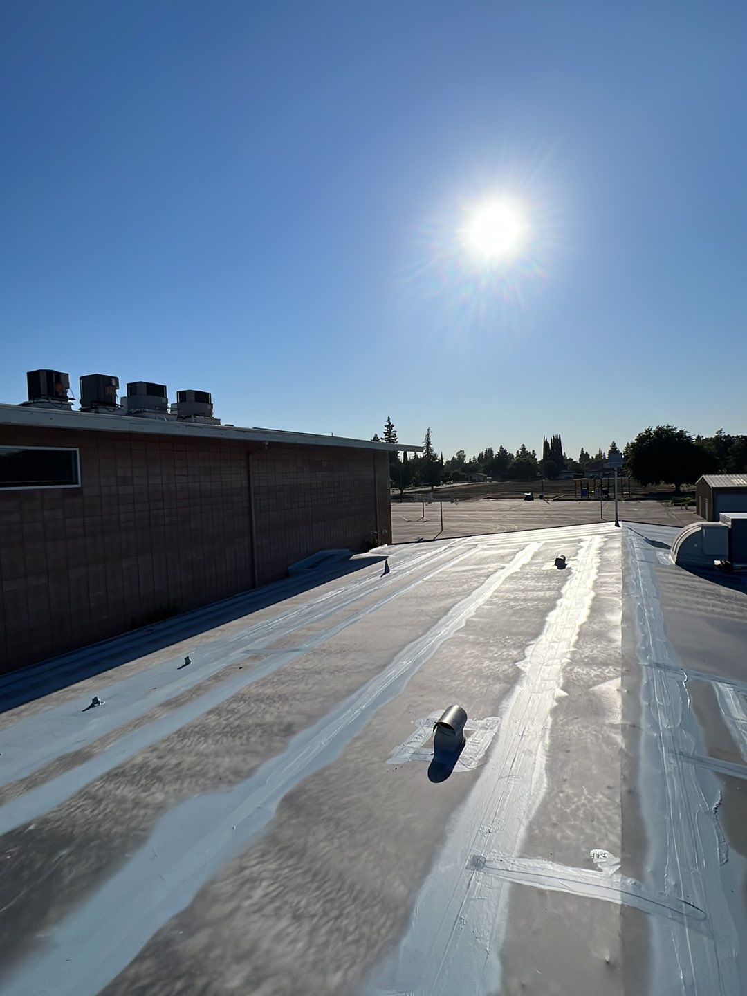 MR Roofing system using Benchmark/PUMA XL coatings over TPO single-ply roofing by Straight Edge Roofing Inc