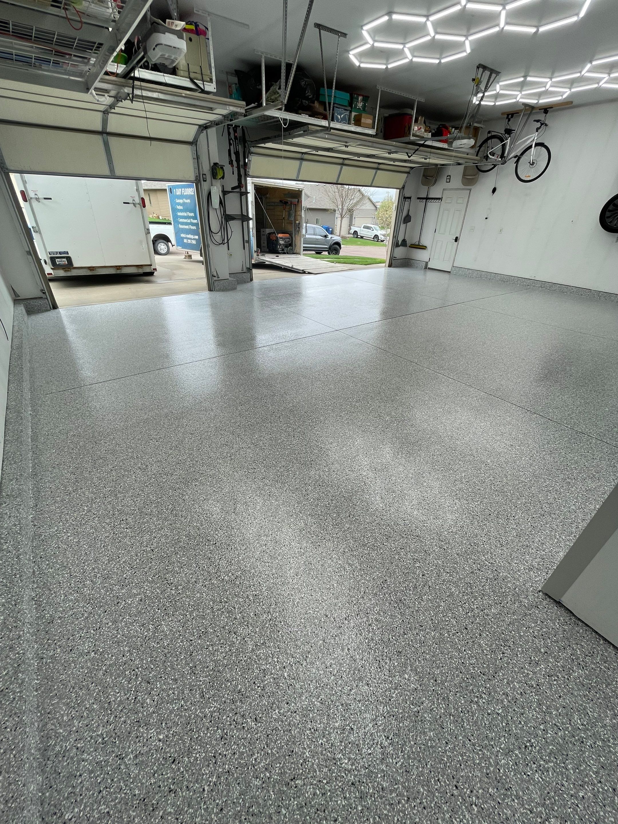 Feather Gray Epoxy Floor Coating Installation in Sioux Falls by Select Painting, Coatings & Garage Cabinets