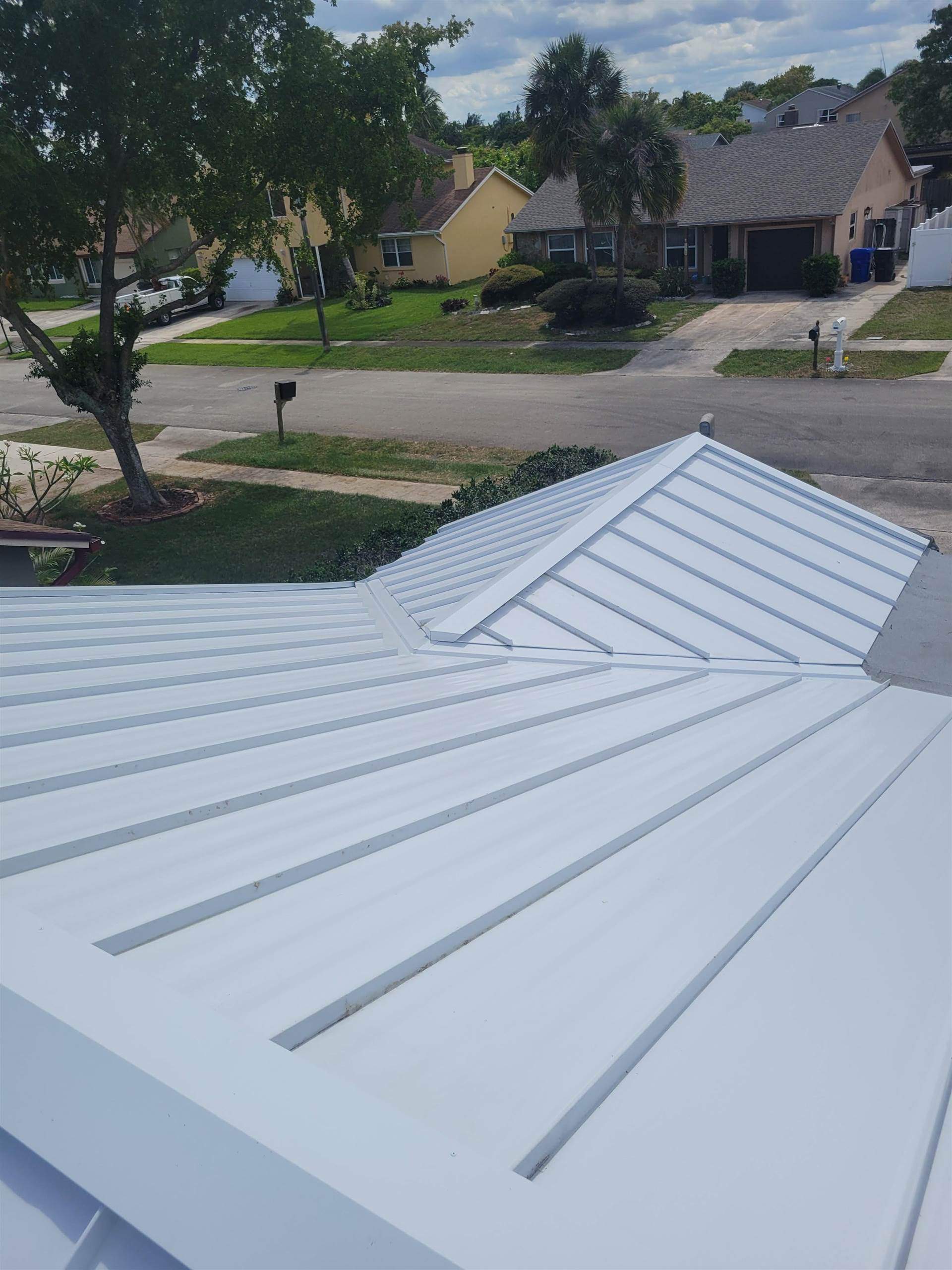 Standing Seam Metal & Flat Re-Roof using 1.5" Nail Strip 24ga Solar White Kynar Coated Standing Seam Metal Panels by Morton Roofing, Inc.